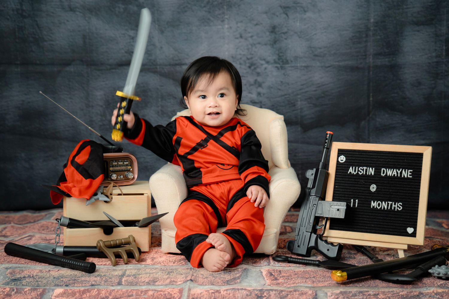 A dark chalkboard background setup with vintage classroom props and wooden blocks.