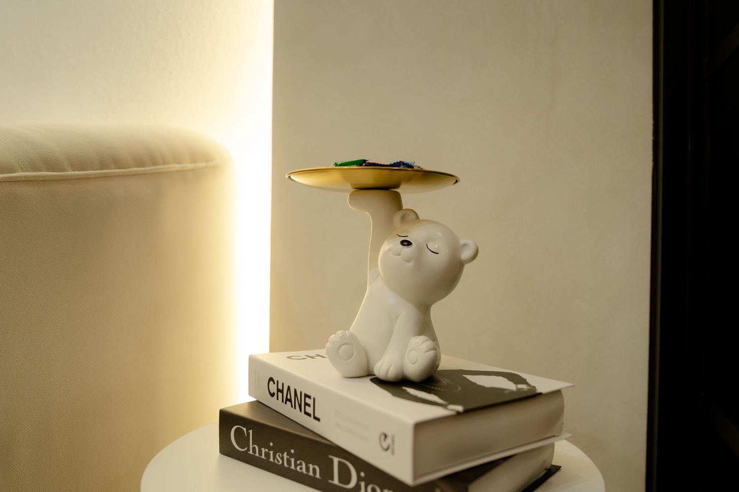 Minimalist shelf display with decorative items illuminated by warm accent lighting.