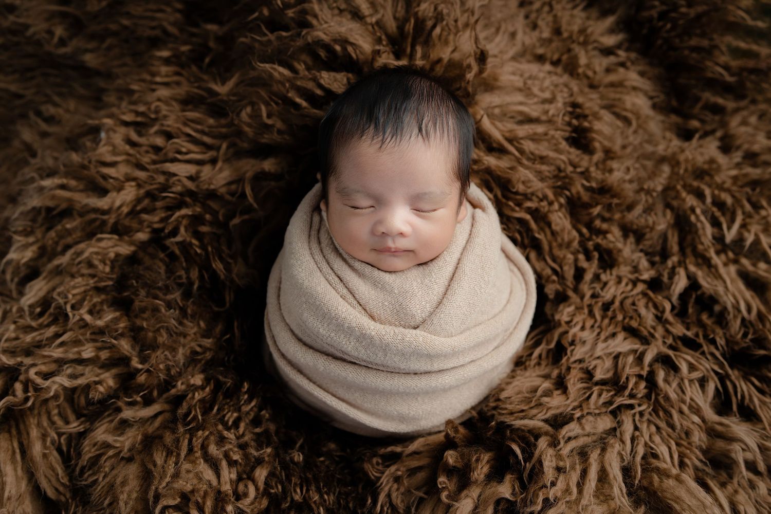 Newborn photography collage with brown fur backdrop and soft neutral wraps showing peaceful sleeping poses.
