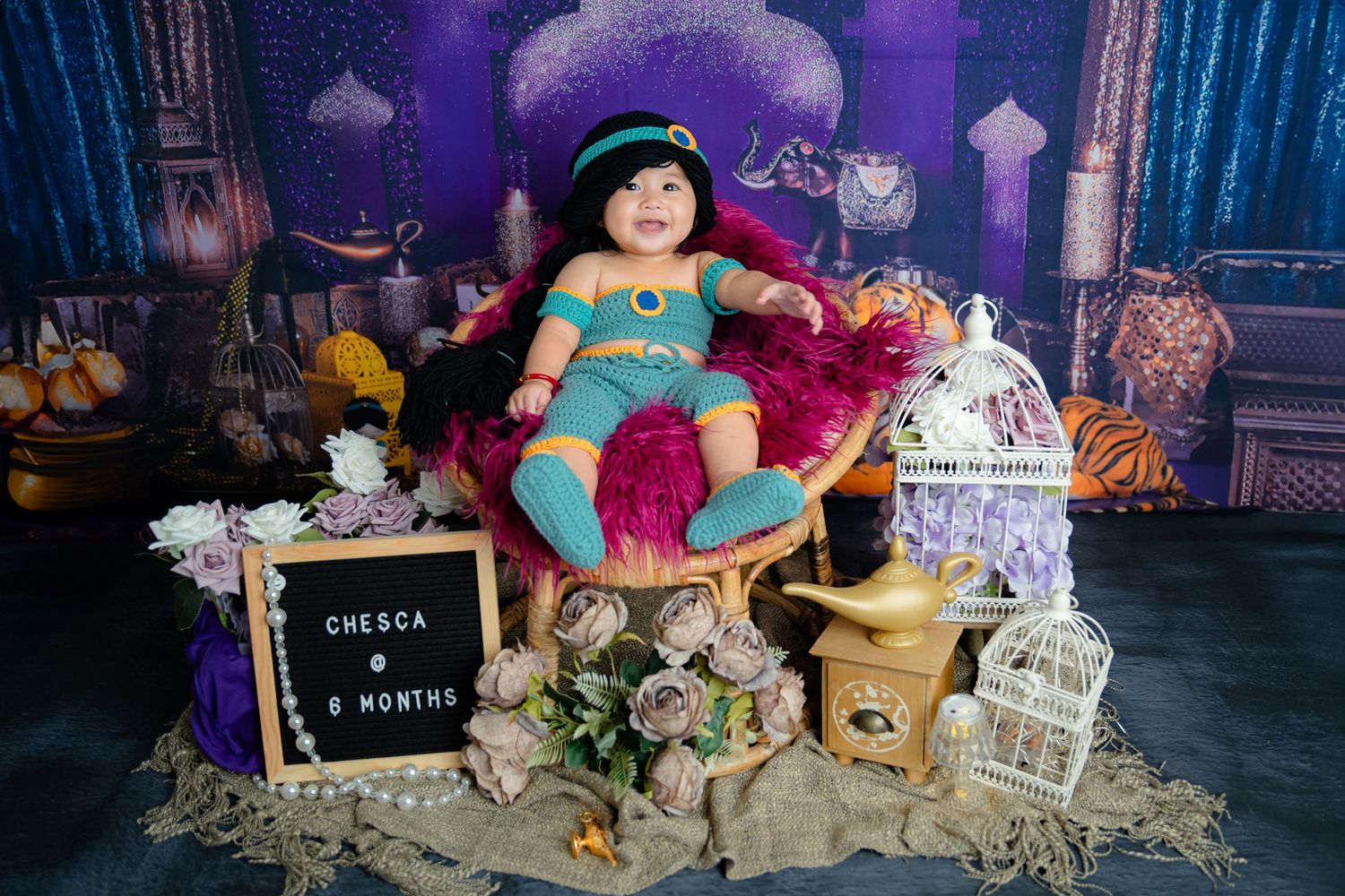Magical fairytale setup with twinkling lights, woodland creatures, and fantasy decorations against purple backdrop.