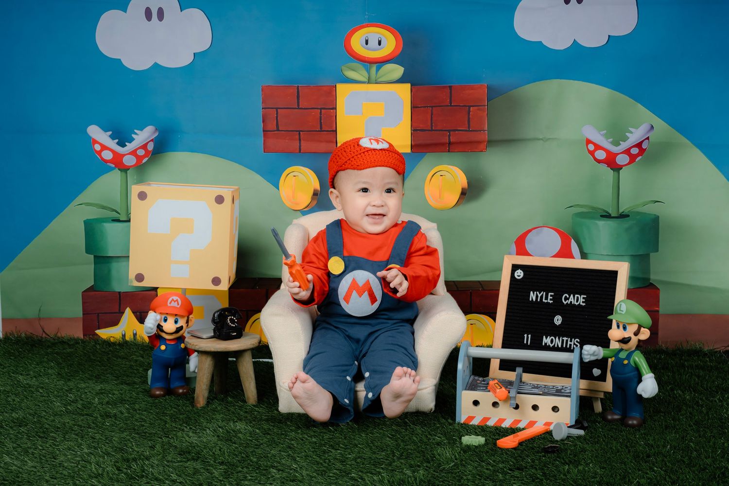 Super Mario themed photoshoot with blue sky backdrop, brick details and game characters.