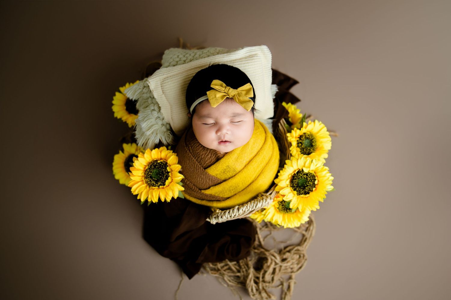 Creative portrait with bright yellow sunflowers and warm tones creating a dramatic artistic composition.