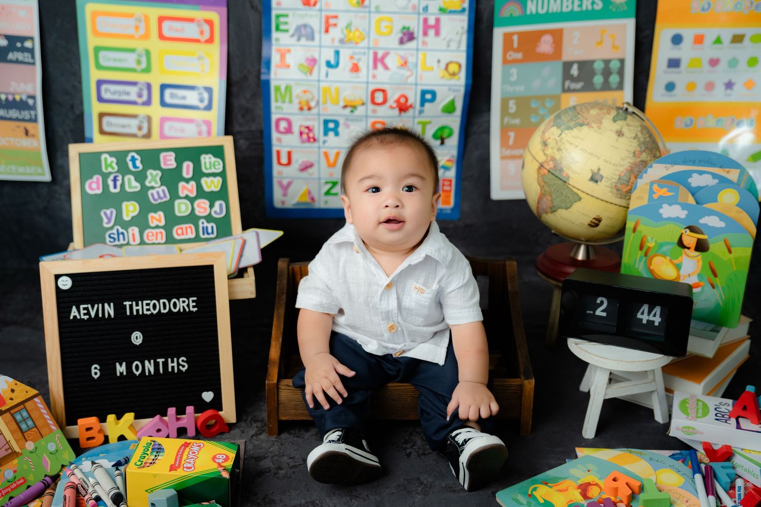 Colorful classroom setting with educational posters, alphabet charts, and learning materials.