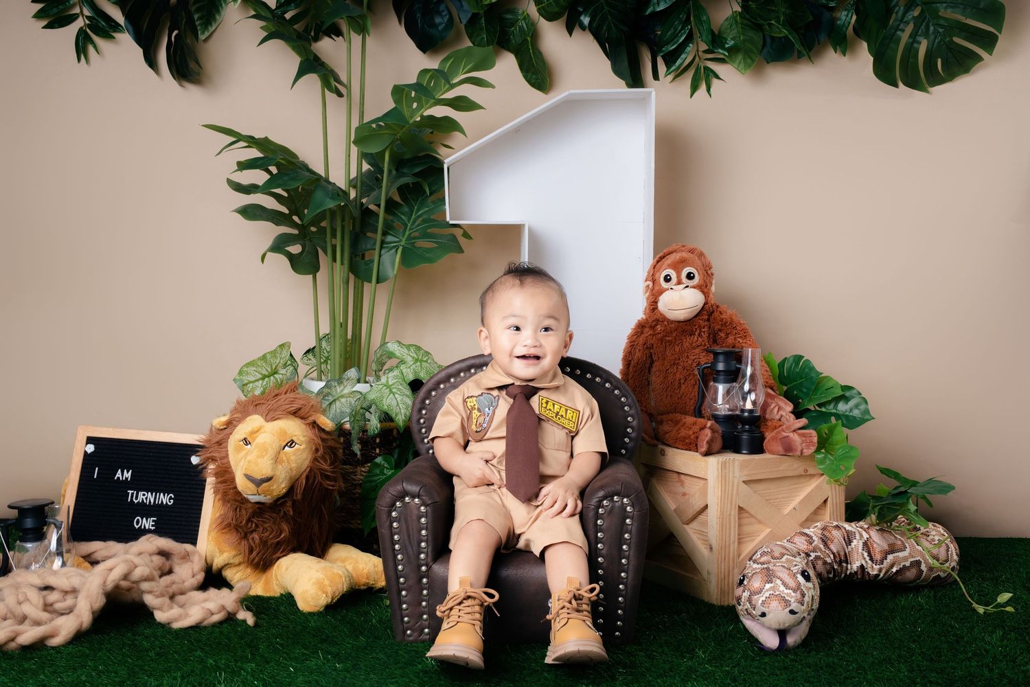 A collection of stuffed animals and decorative items arranged on a shelf with tropical plants and monstera leaves.