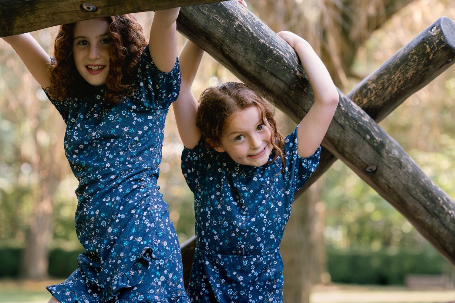 Two girls smiling while playing at playground
