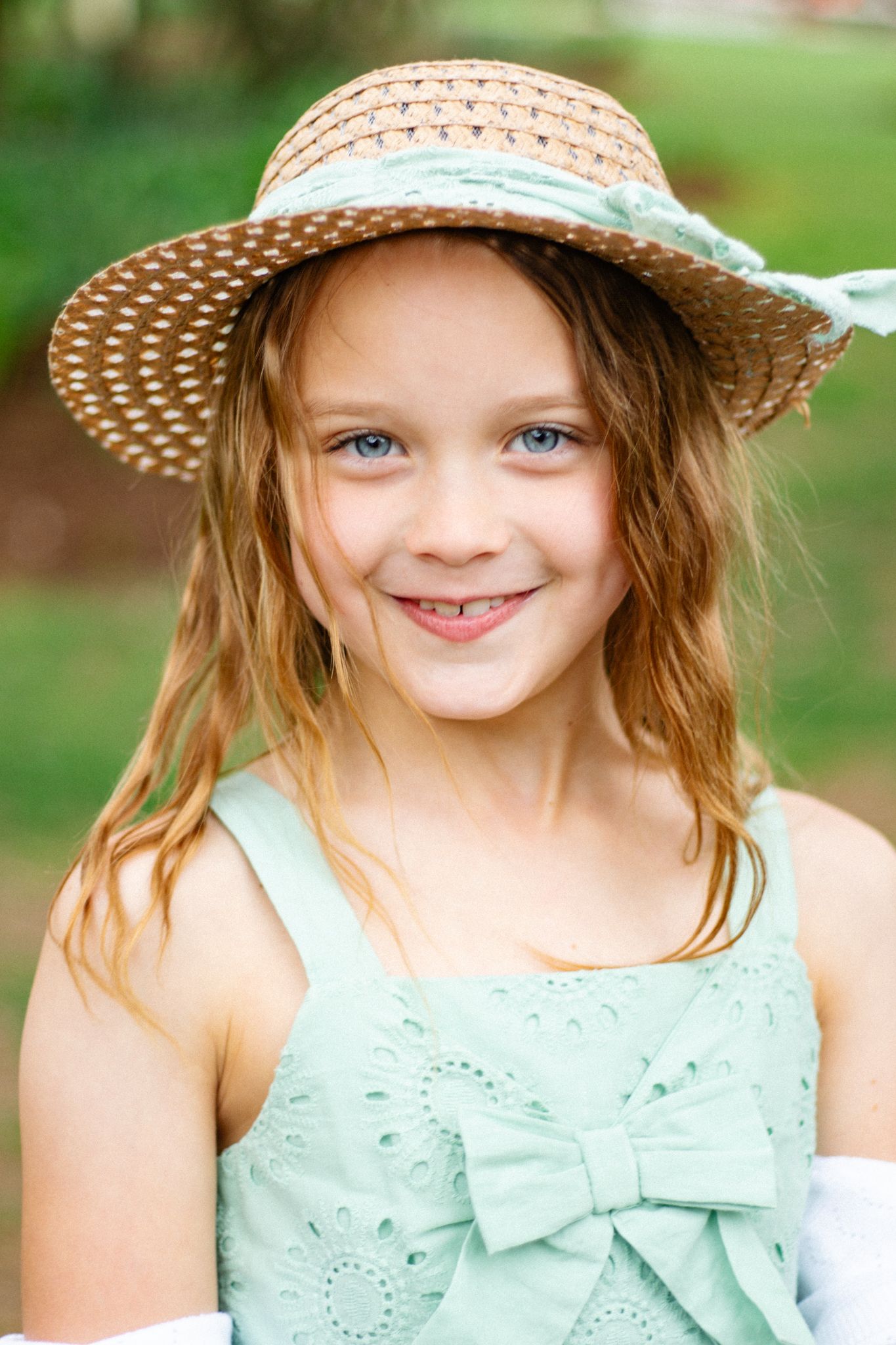 Garden portraits in mint eyelet dress and straw hat with natural lighting.
