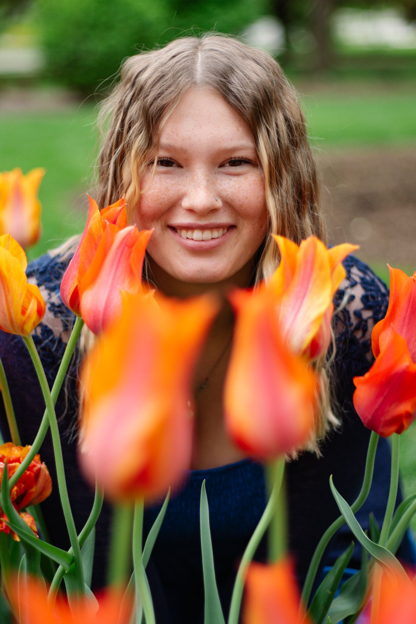Beautiful orange tulips in the foreground with soft bokeh background in a spring garden setting.