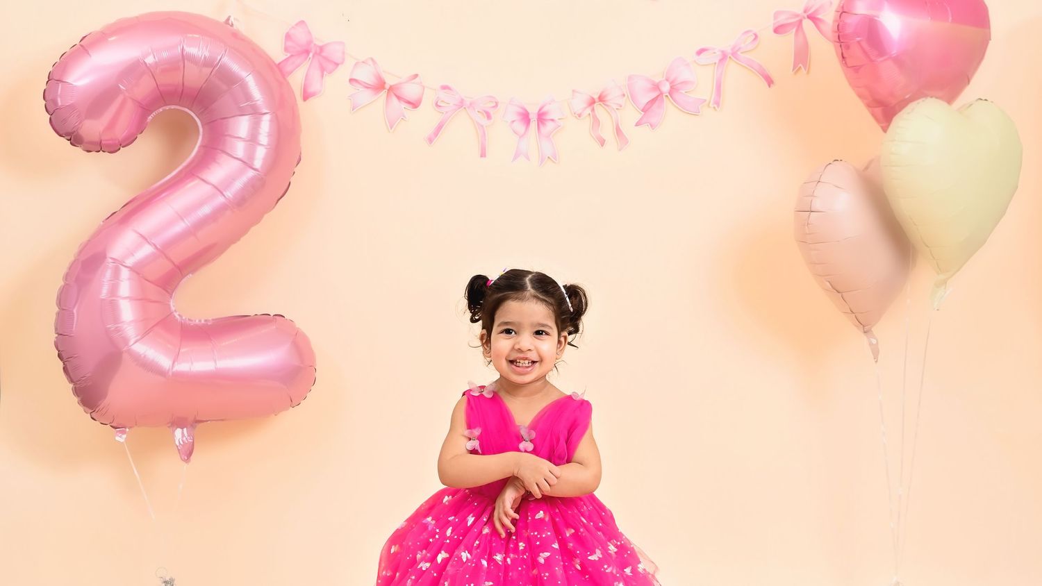 Studio portrait of a two-year-old baby celebrating a second birthday
