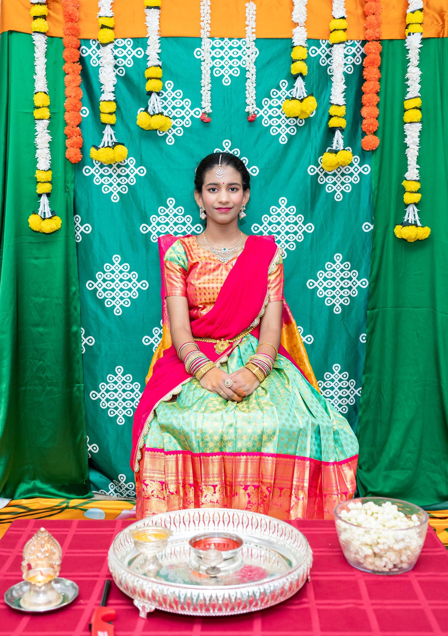 Half-saree ceremony portrait of a young woman in traditional attire, captured indoors and outdoors by ek-framedmemories