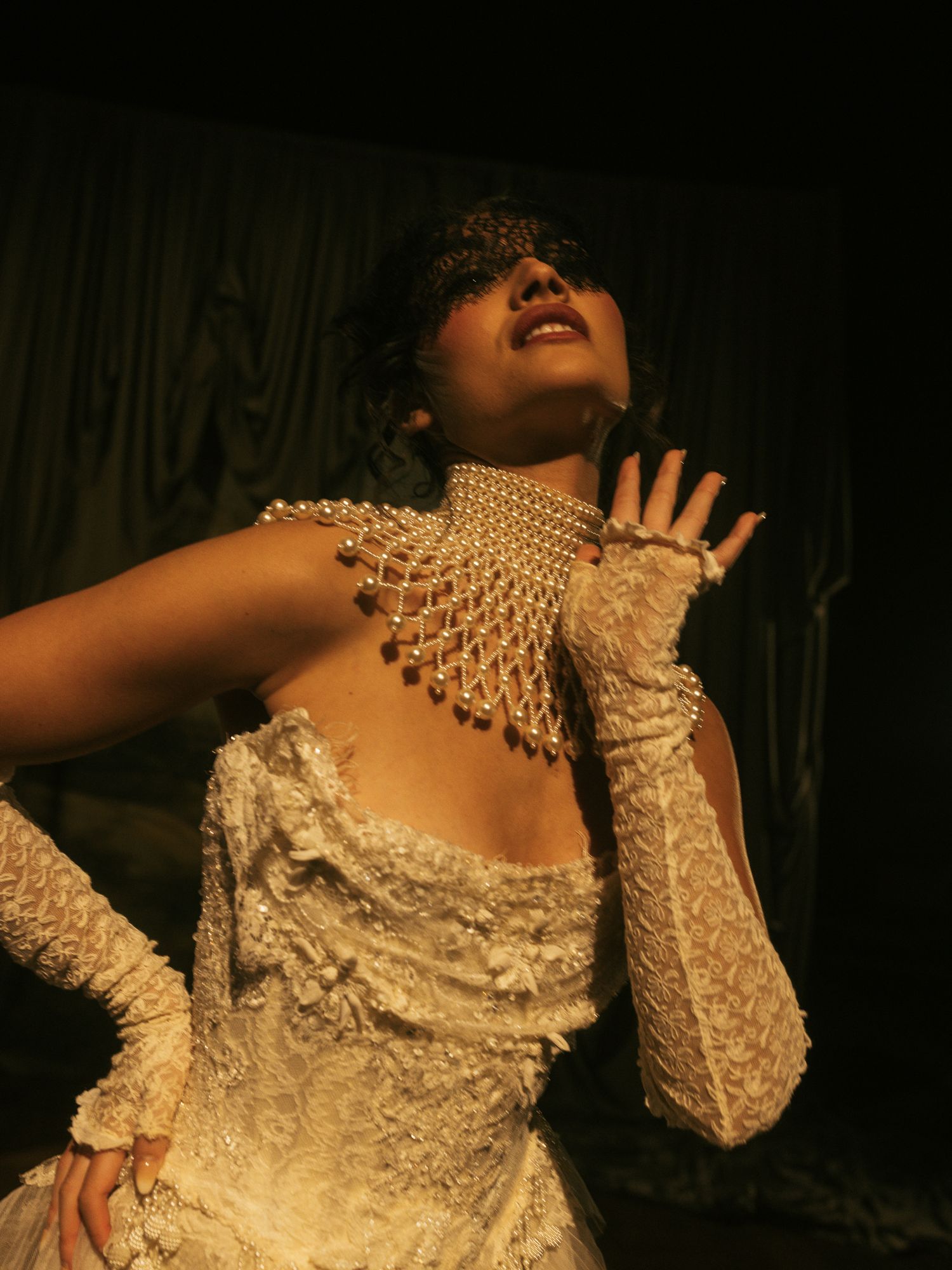 Dramatic series of artistic portraits showing expressive movements in an ornate cream-colored Victorian style dress.