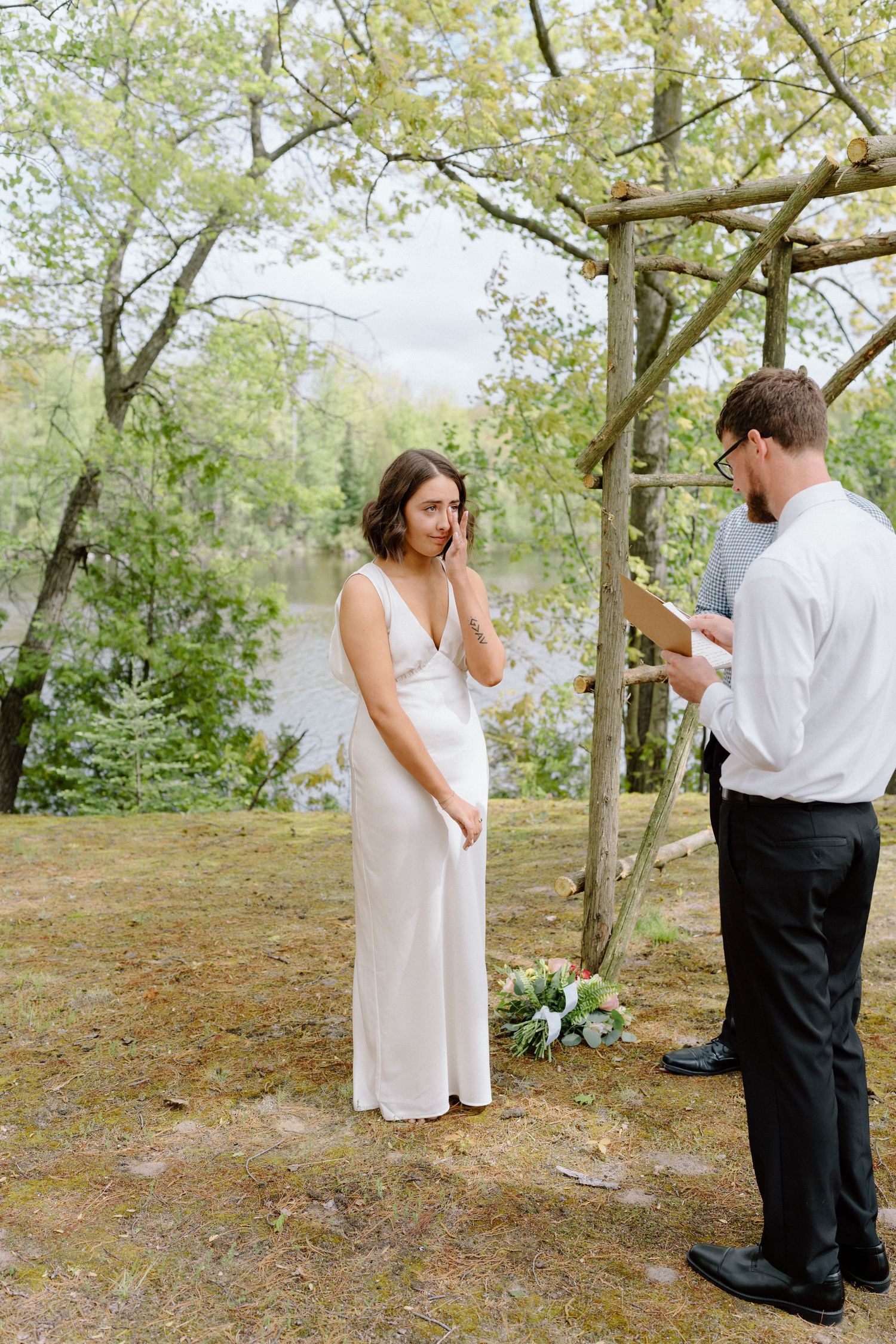 Romantic outdoor wedding first look sequence in a scenic wooded setting.