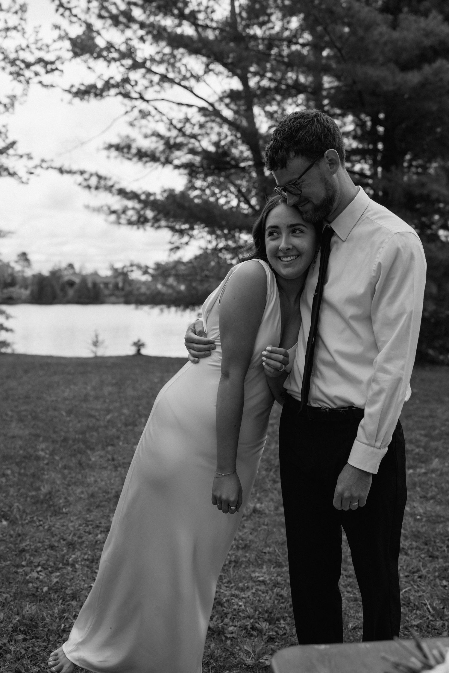 A couple laughs together during a playful outdoor photoshoot.