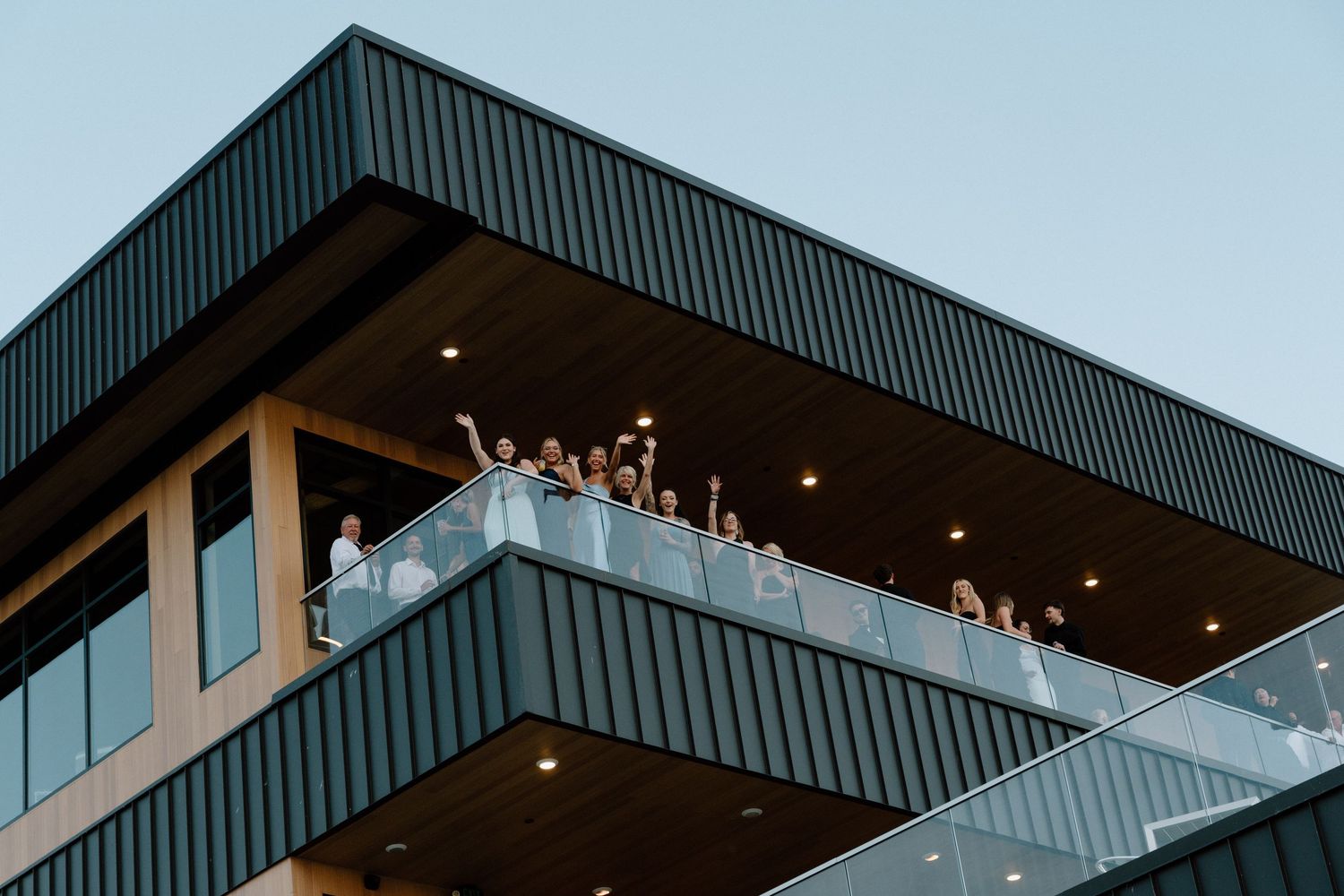 Modern architectural exterior with corrugated metal siding and clean geometric lines against blue sky.