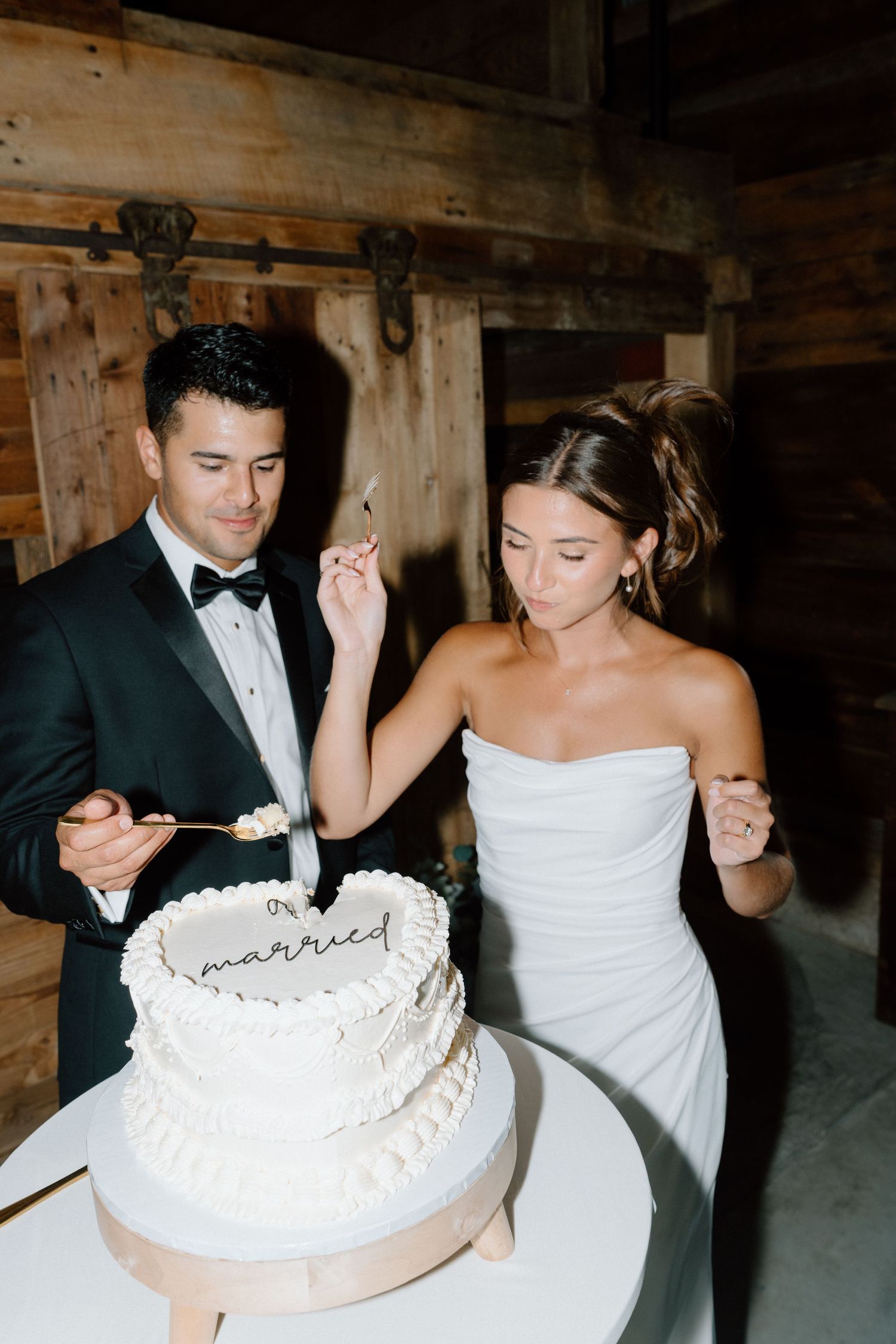 Wedding cake cutting sequence with a white frosted cake decorated with 'married' text.