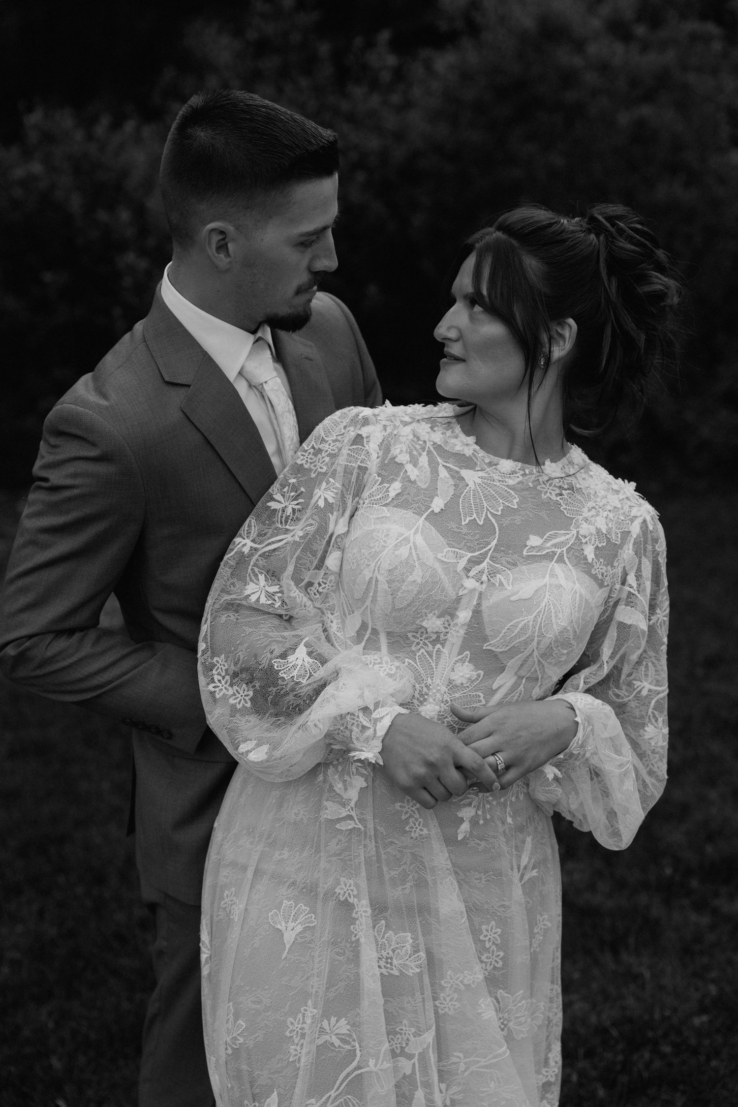 Intimate black and white photos of couple in wedding attire showing tender moments.