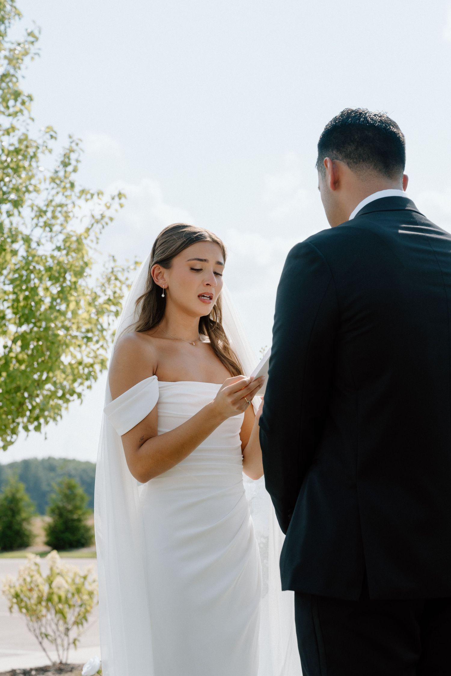 Intimate outdoor wedding ceremony moment under natural lighting.