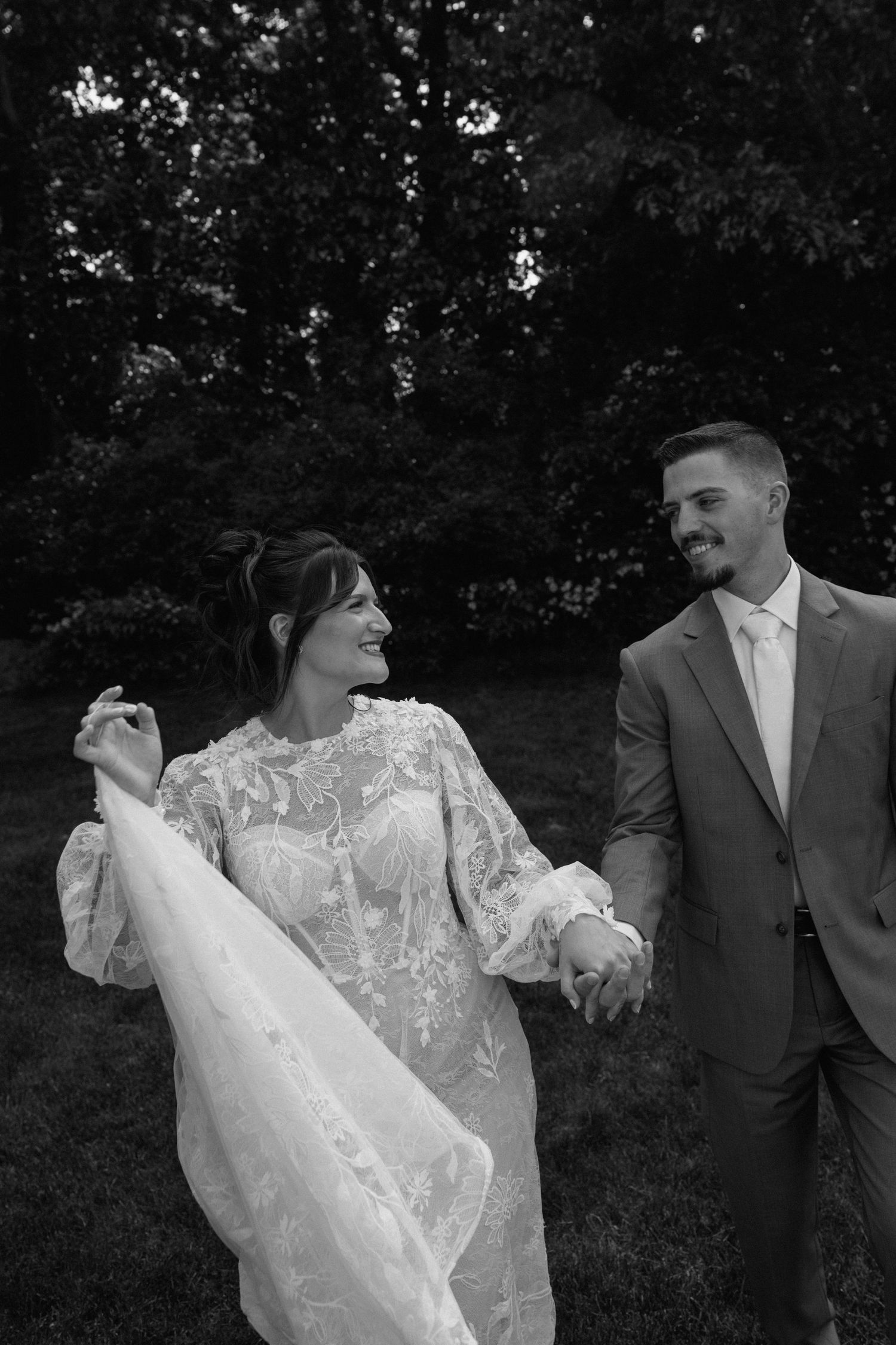 Black and white candid shots of newlyweds sharing romantic moments outdoors.