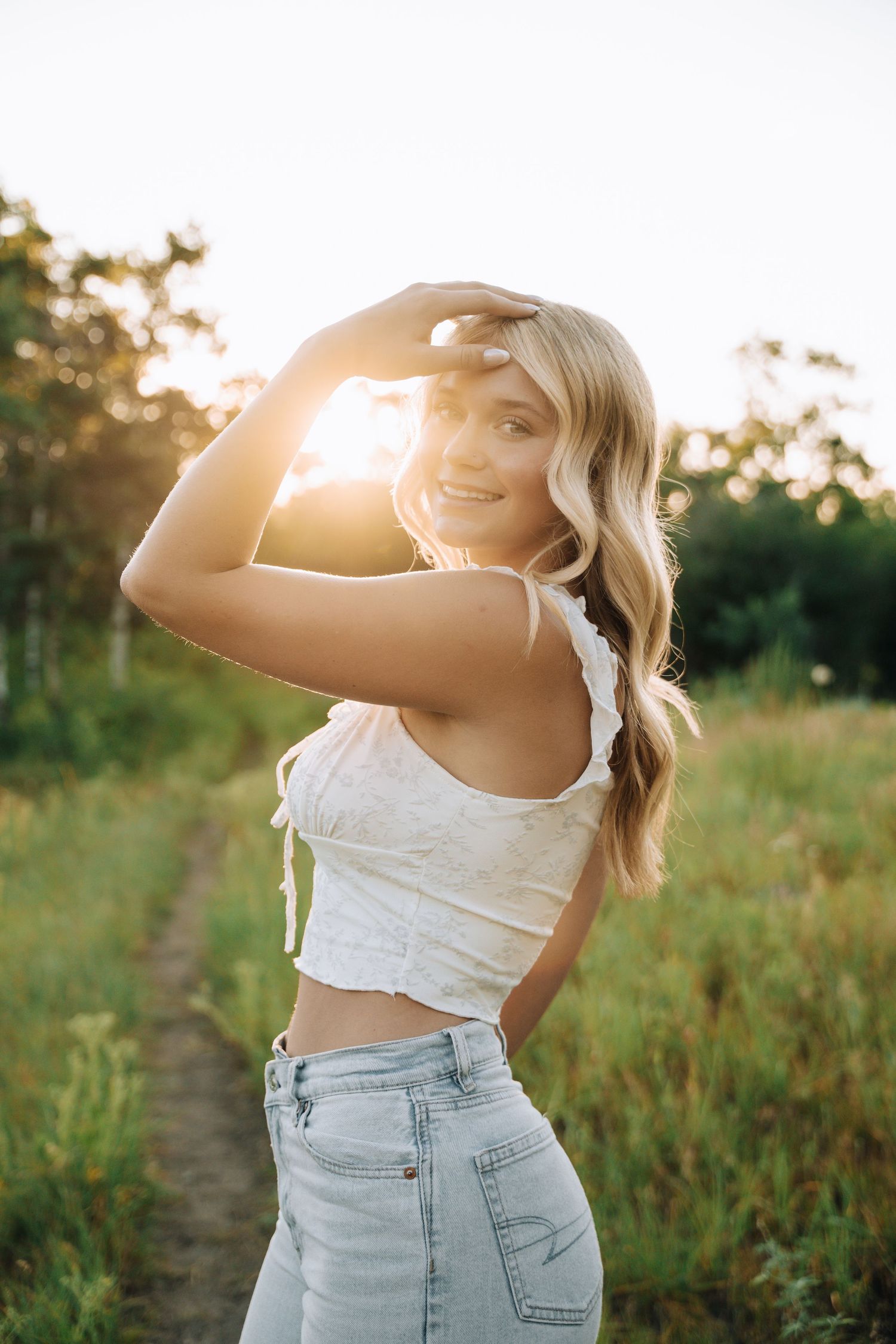 Girl looking at camera with sun shining from the back.