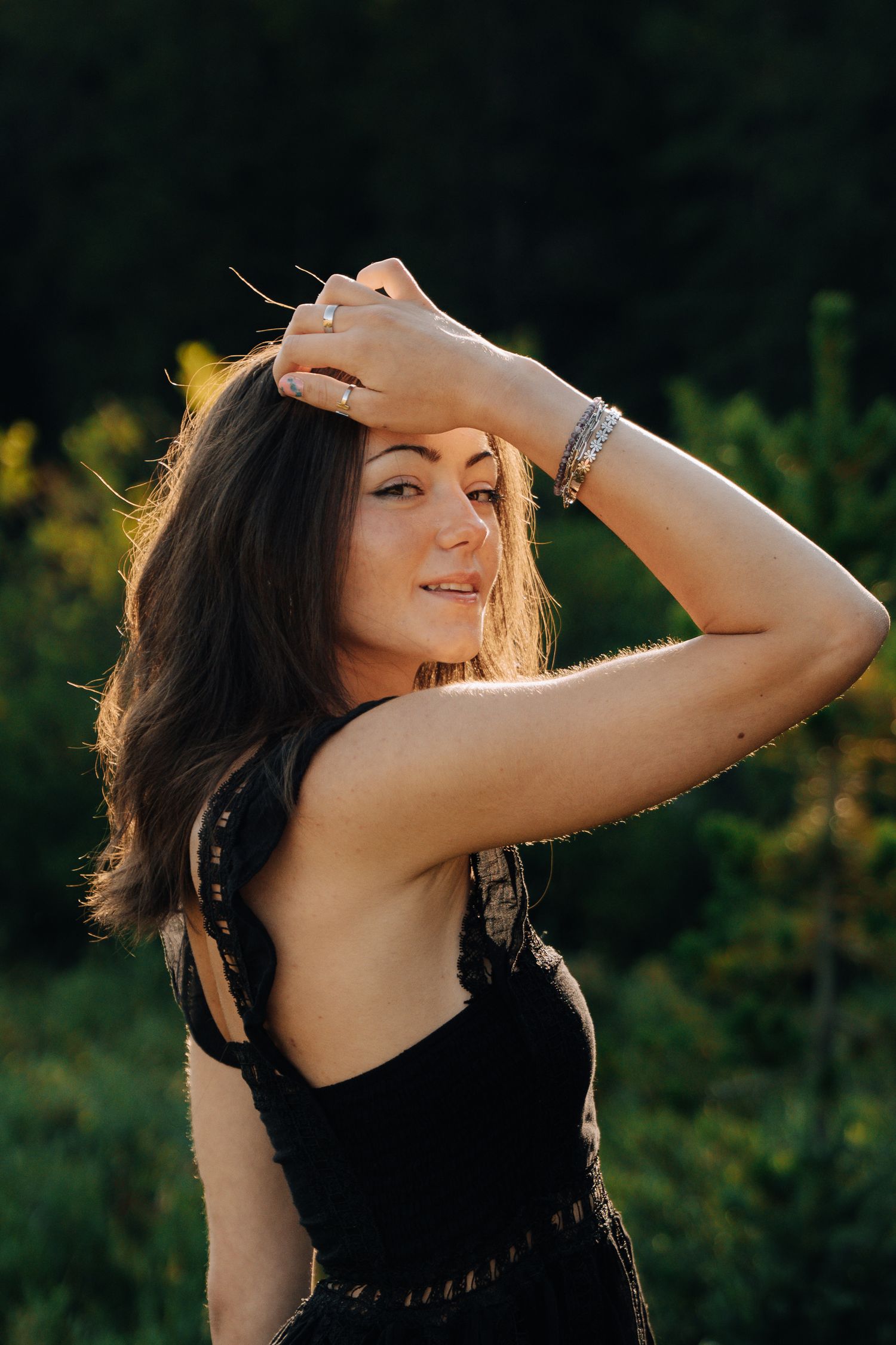 Womens senior session next to river while wearing flowy clothes