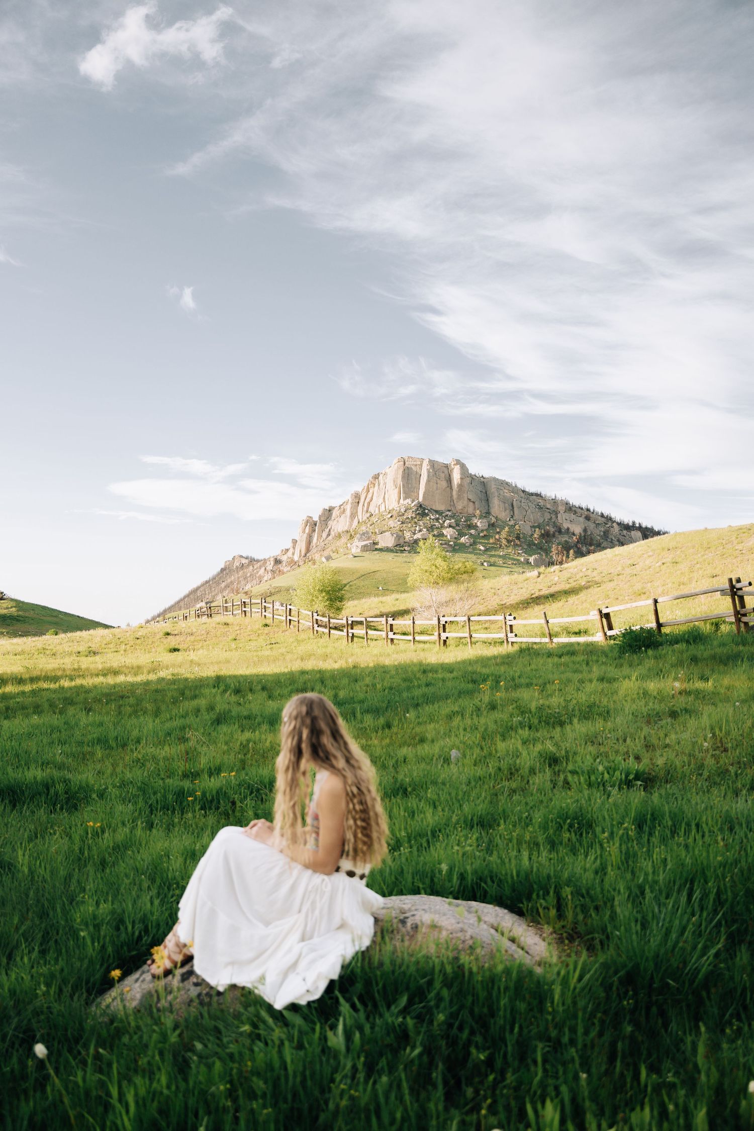 Senior Sitting on a rock in front of steamboat