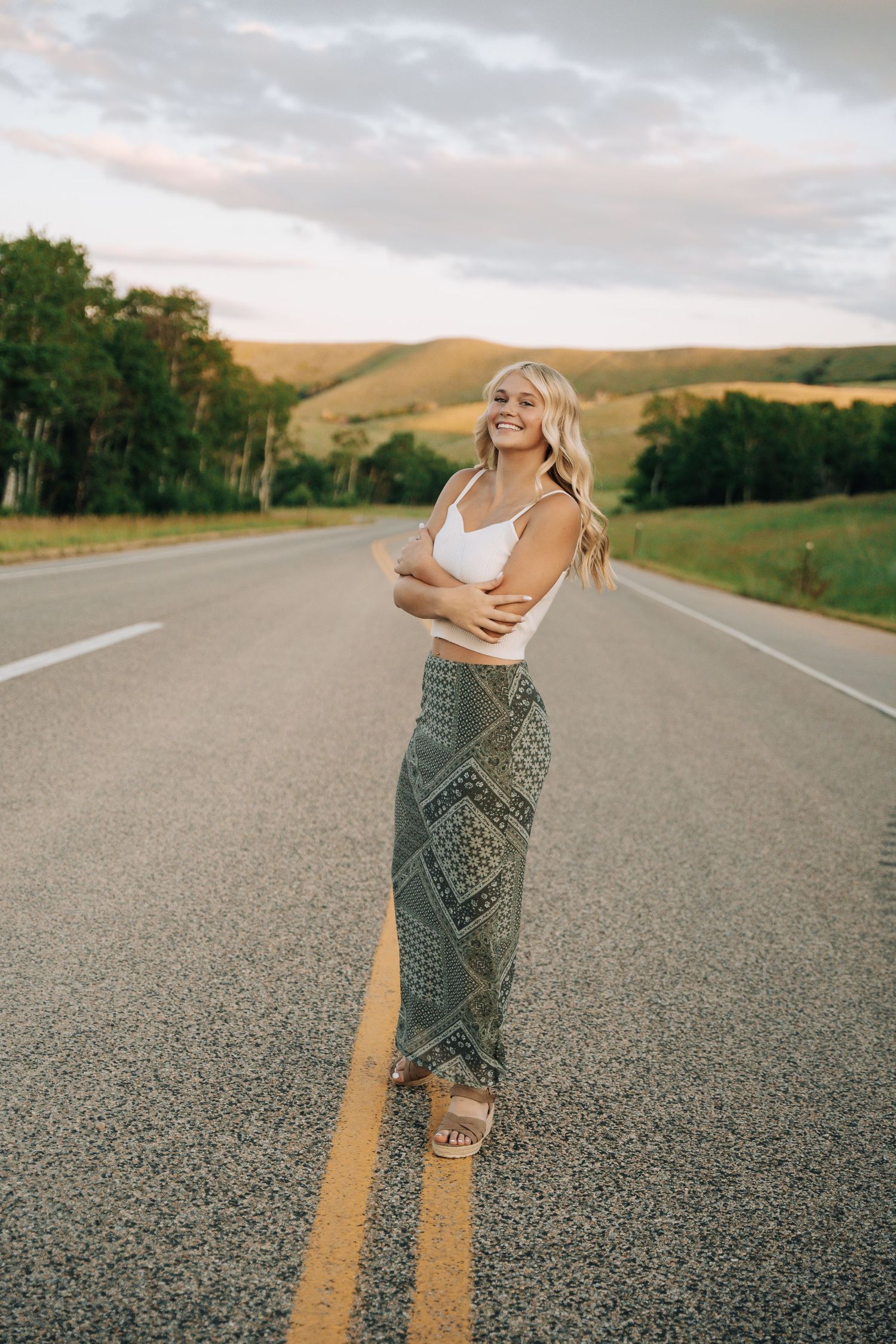 Girl standing the middle of a road walking towards the camera.