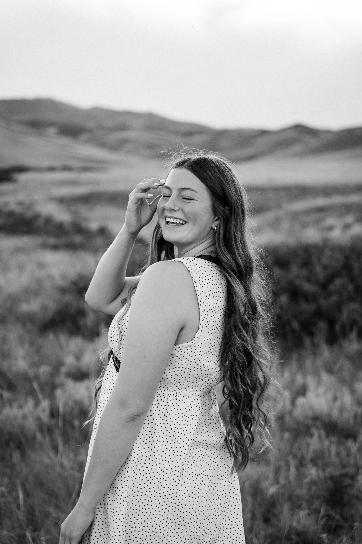 Girl looking over her shoulder with her eyes closed.