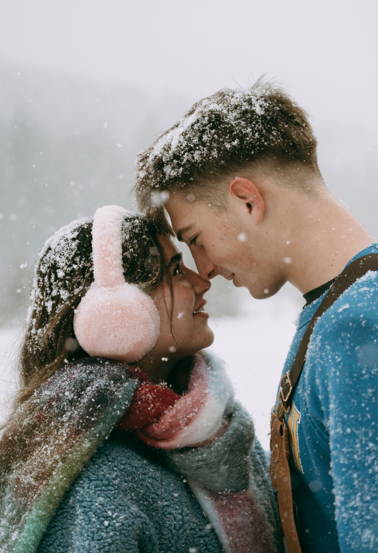 A couple standing face to face in the snow