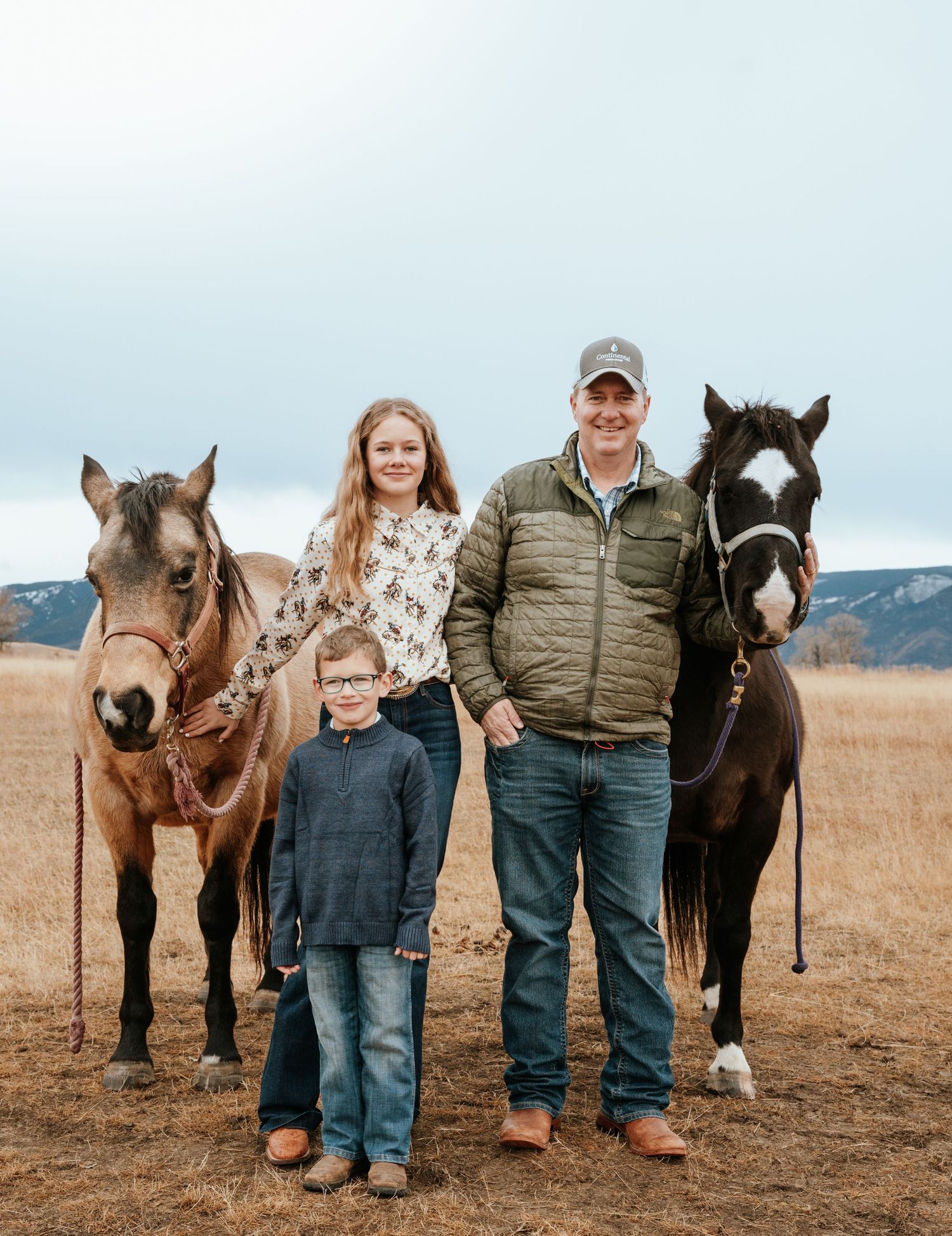 family photo, posing with horses.