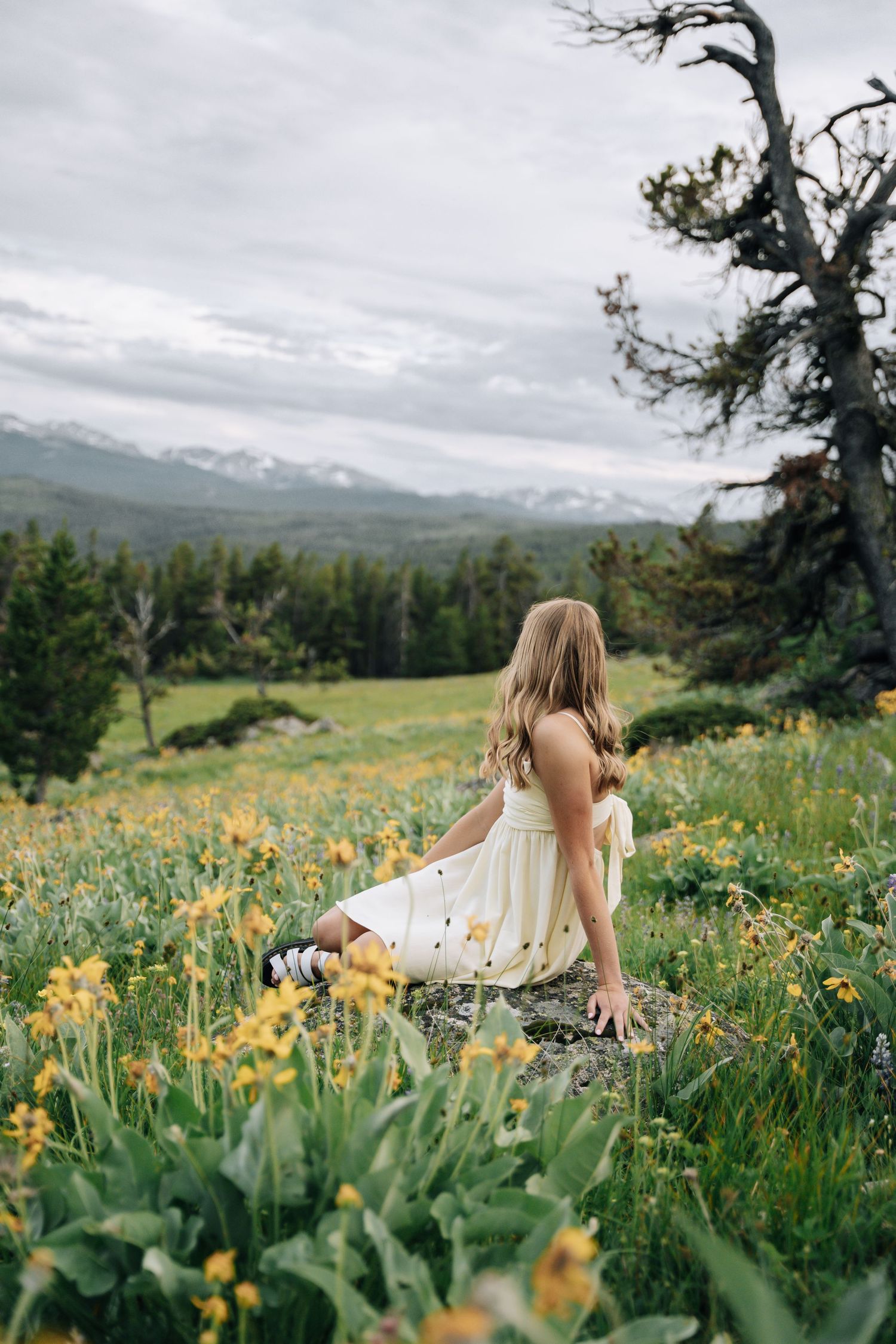 girl looking off into distance towards the mountains.