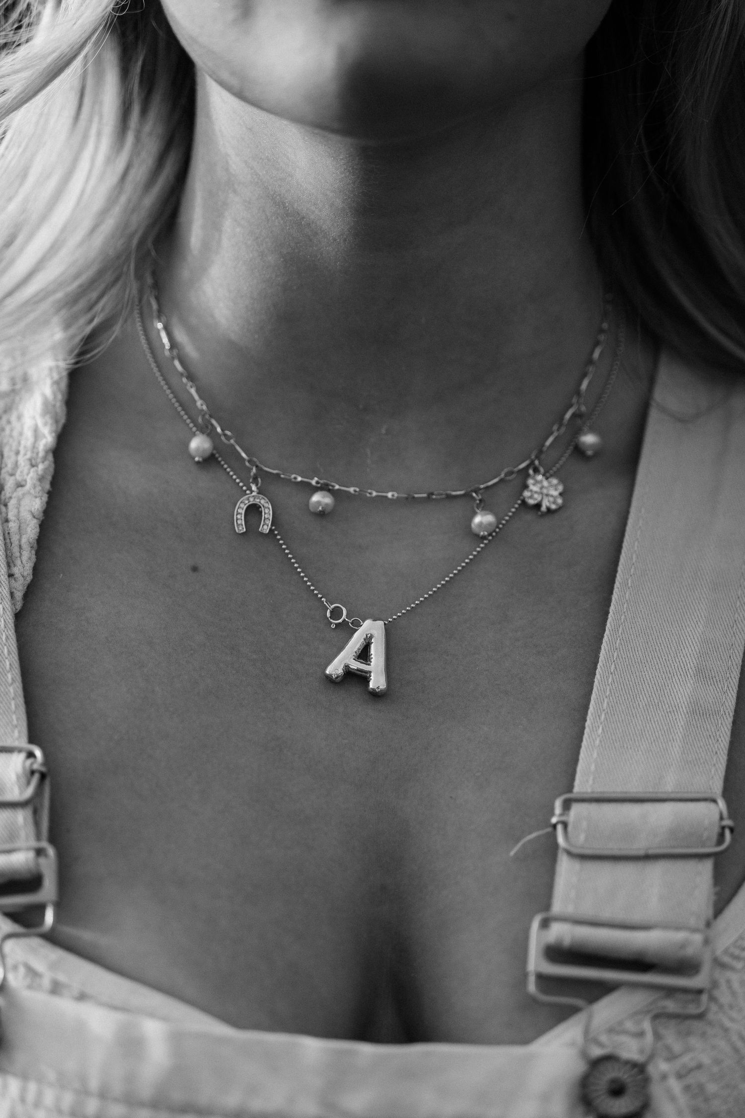 Detail shot of a girls necklaces.