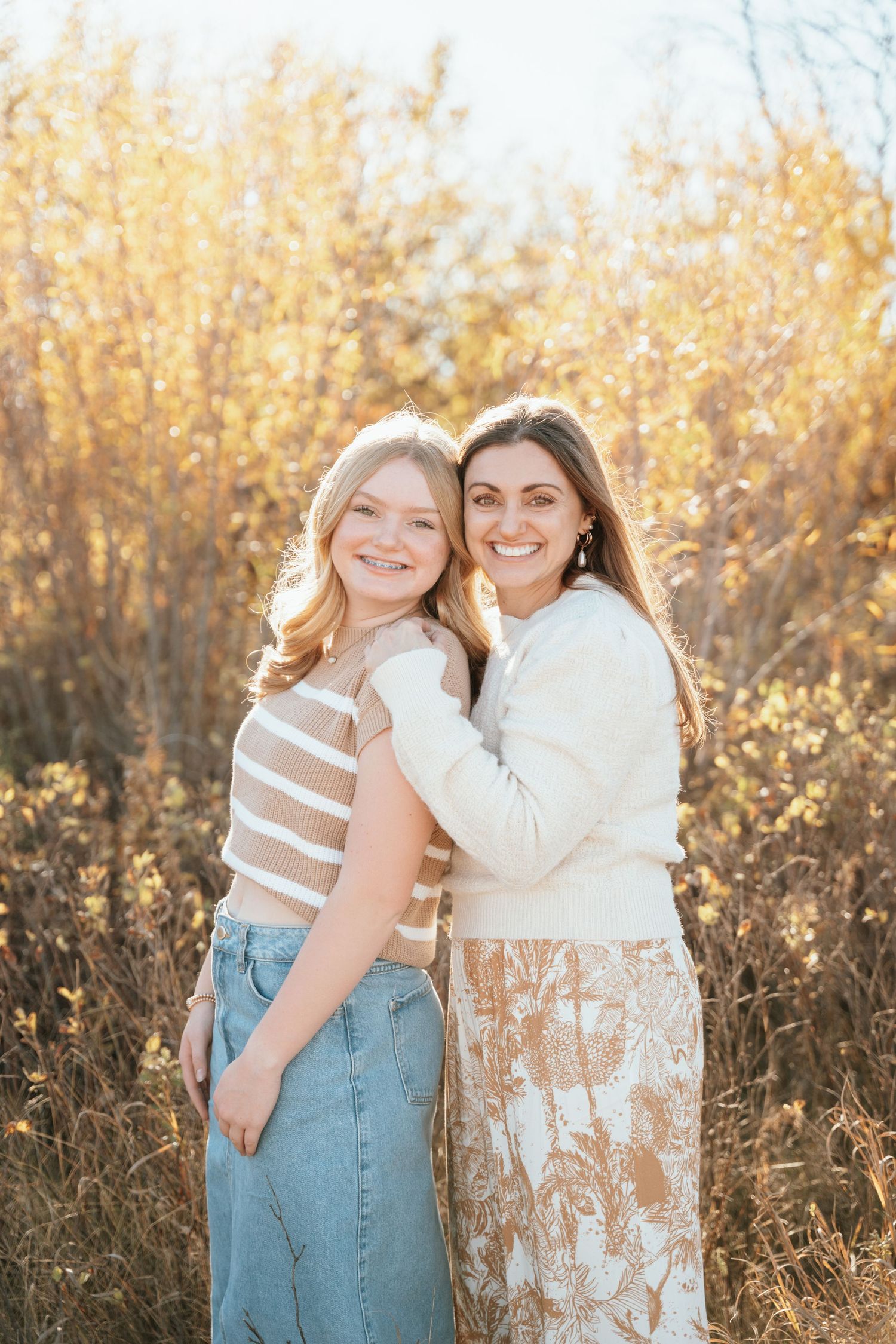 Mom and teen daughter posing.