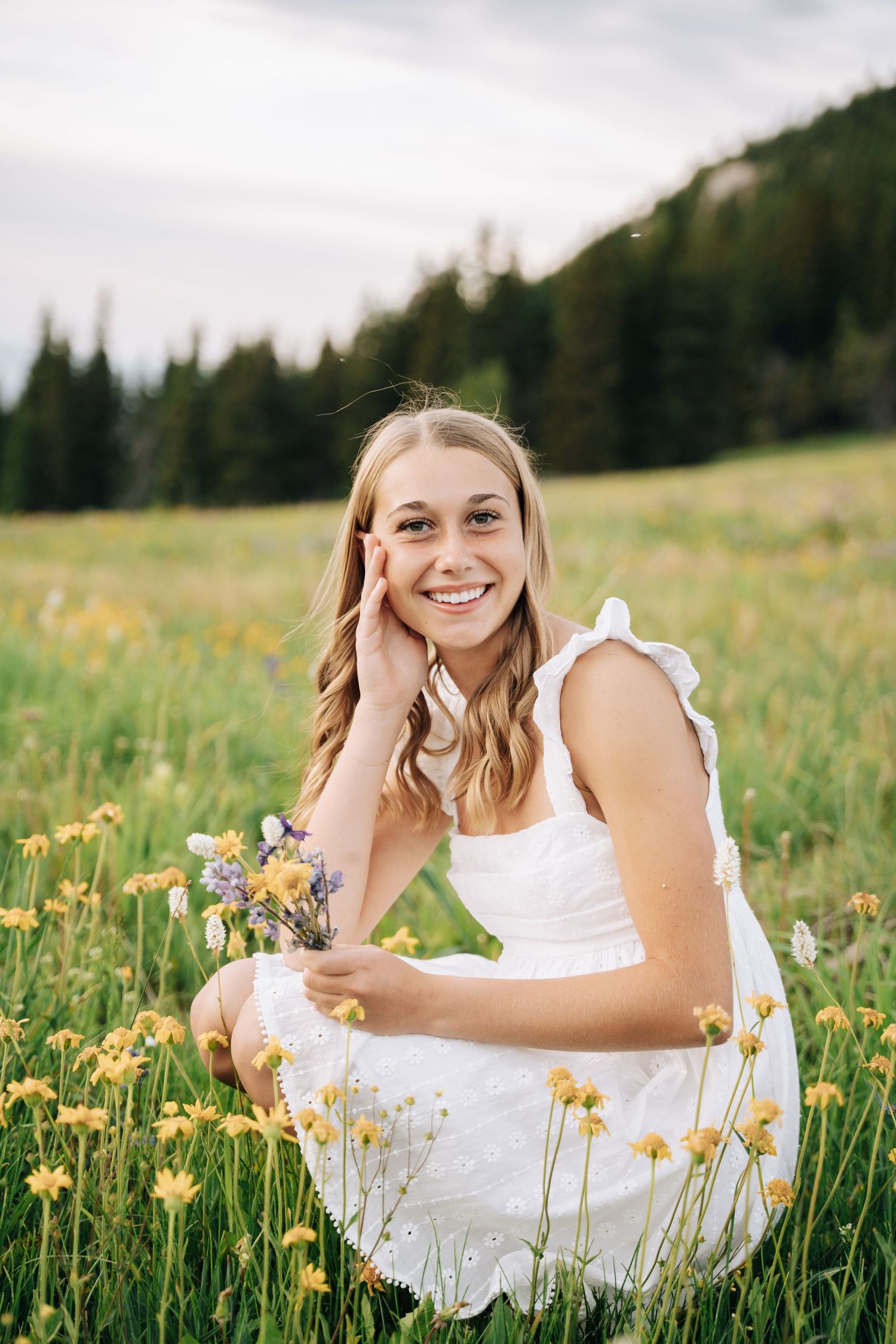 Girl looking into camera with her head propped in her hand.