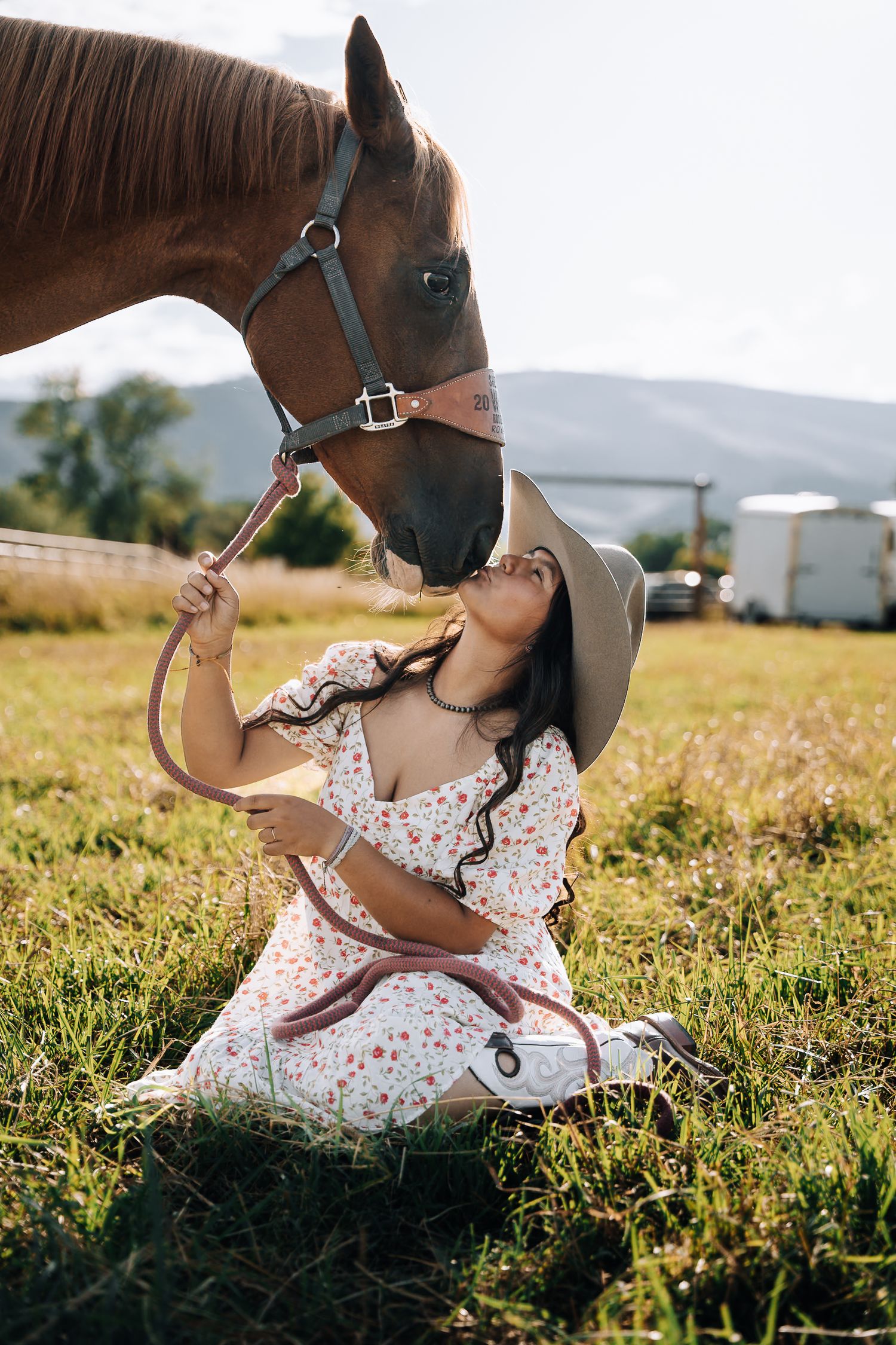Girl sitting next to a horse