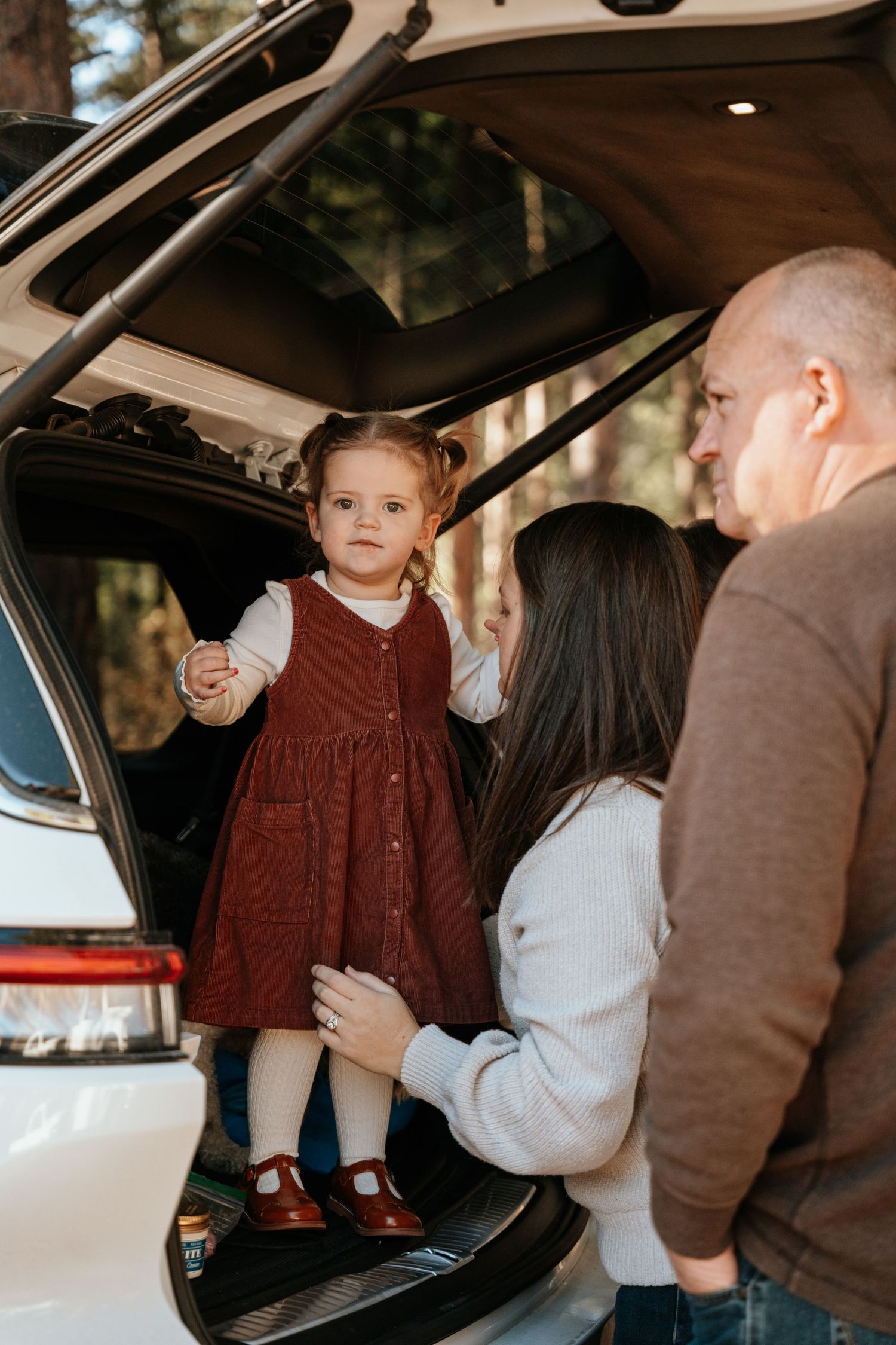 candid behind the scened moment of grandparents looking at child.