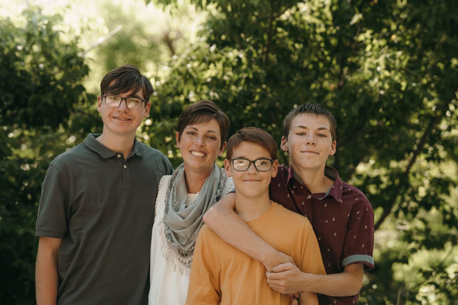 Mother posing with her sons for a photo