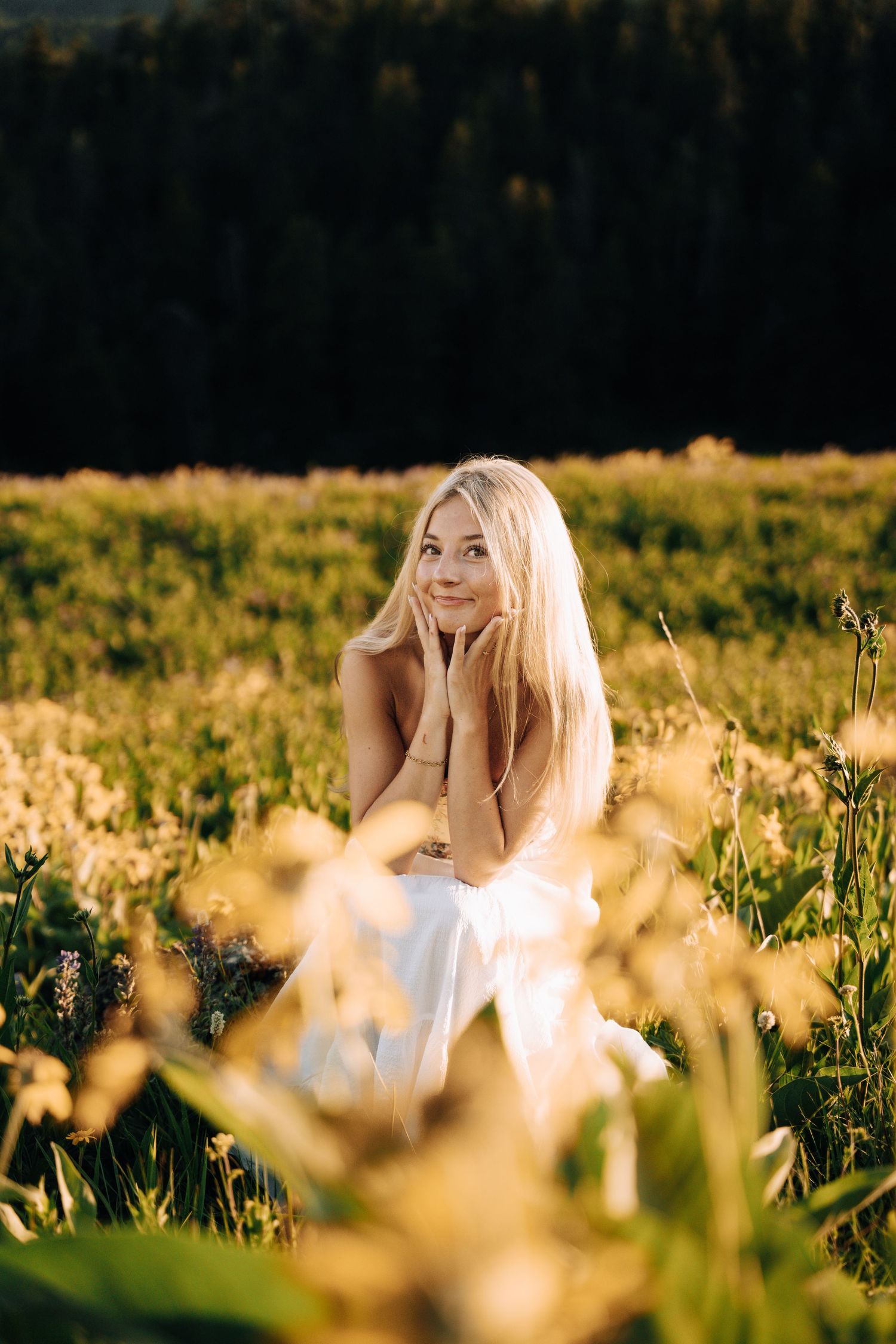 Girl sitting in a flower field.