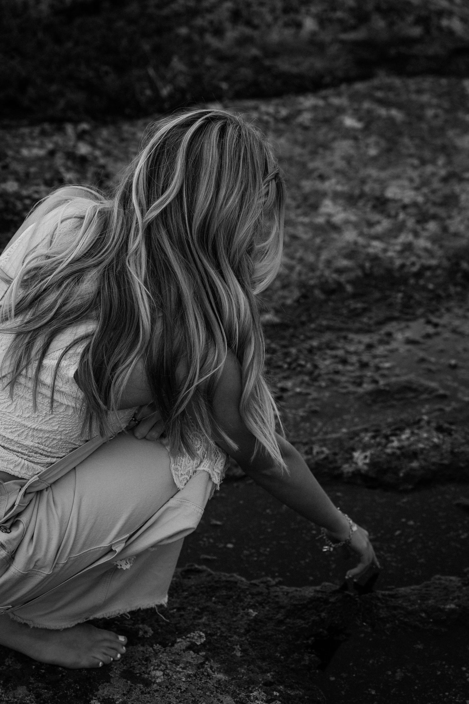 Candid shot of a girl tracing her finger in some water.