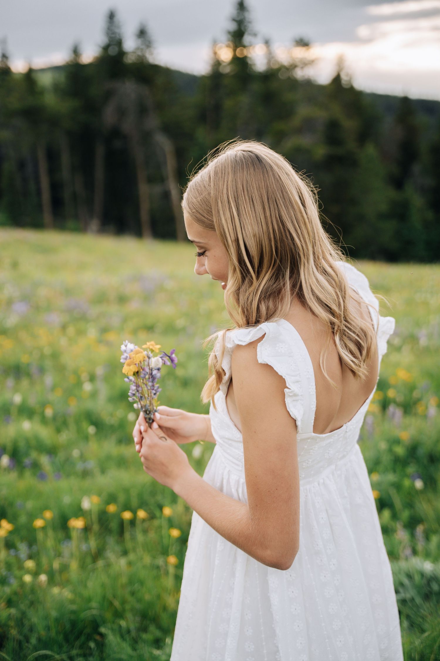 Senior girl looking at flower