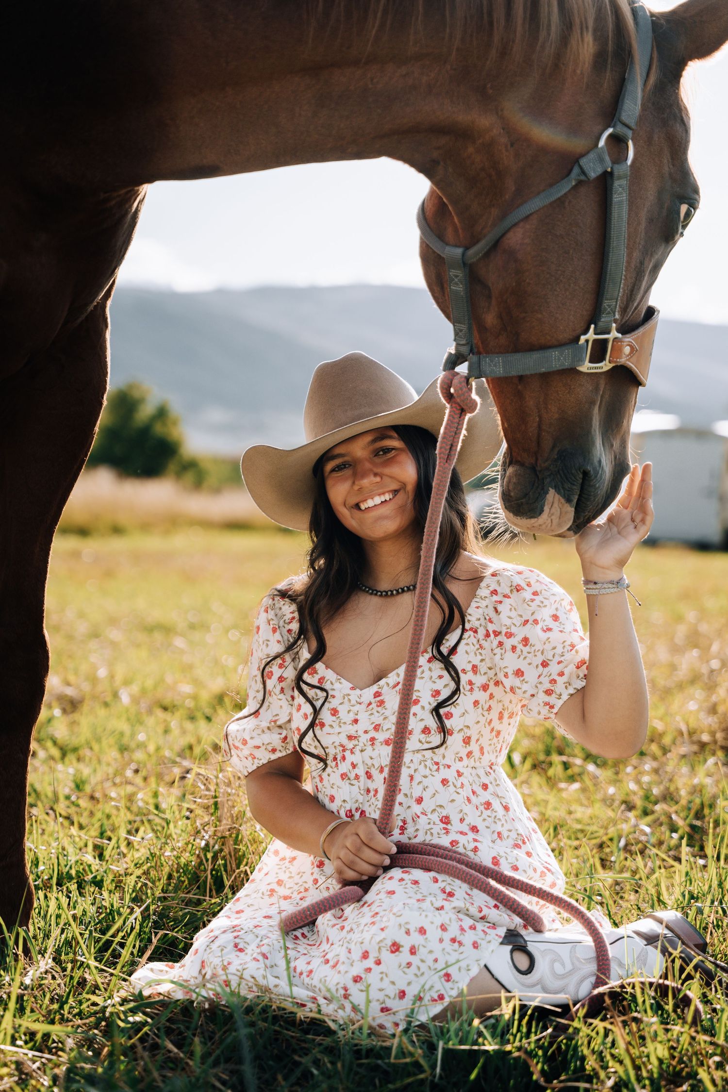 Girl sitting next to a horse