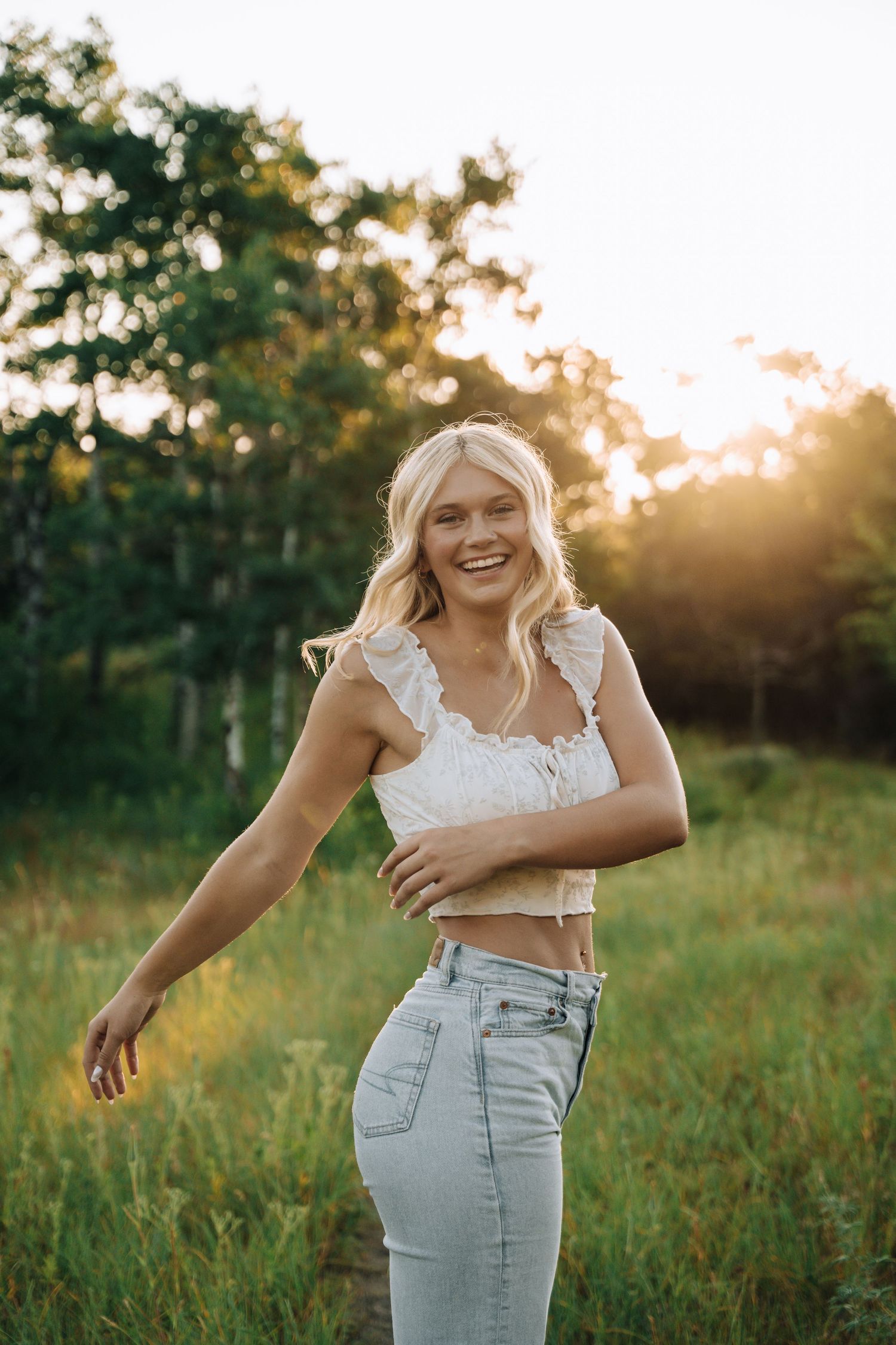 Girl looking at camera with sun shining from the back.