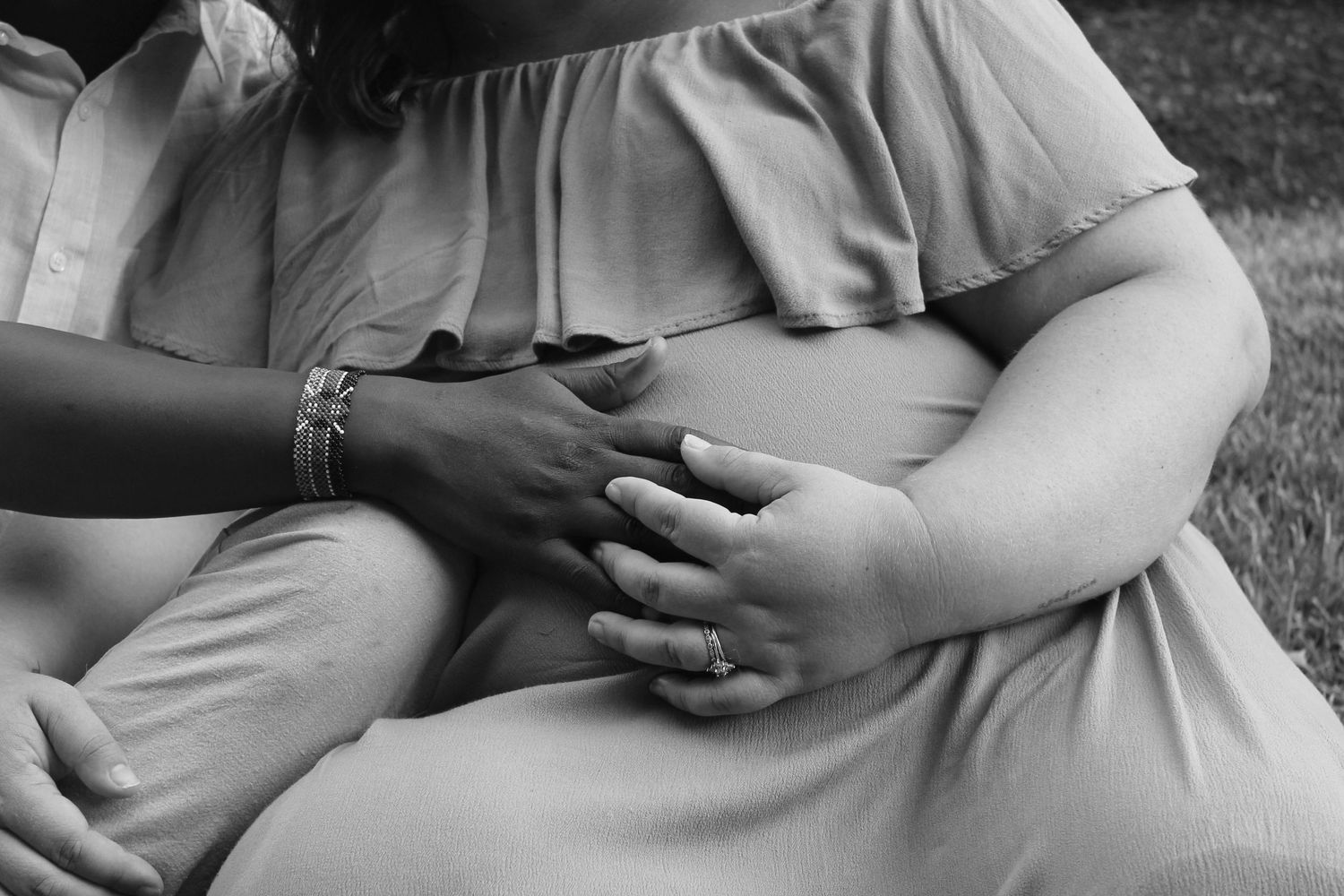 Series of black and white close-up shots showing rings and hands.