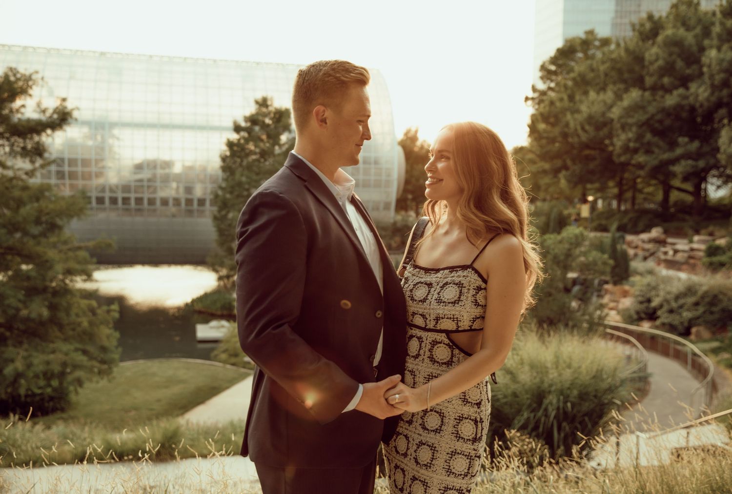 A couple sharing an intimate moment in an urban park setting.