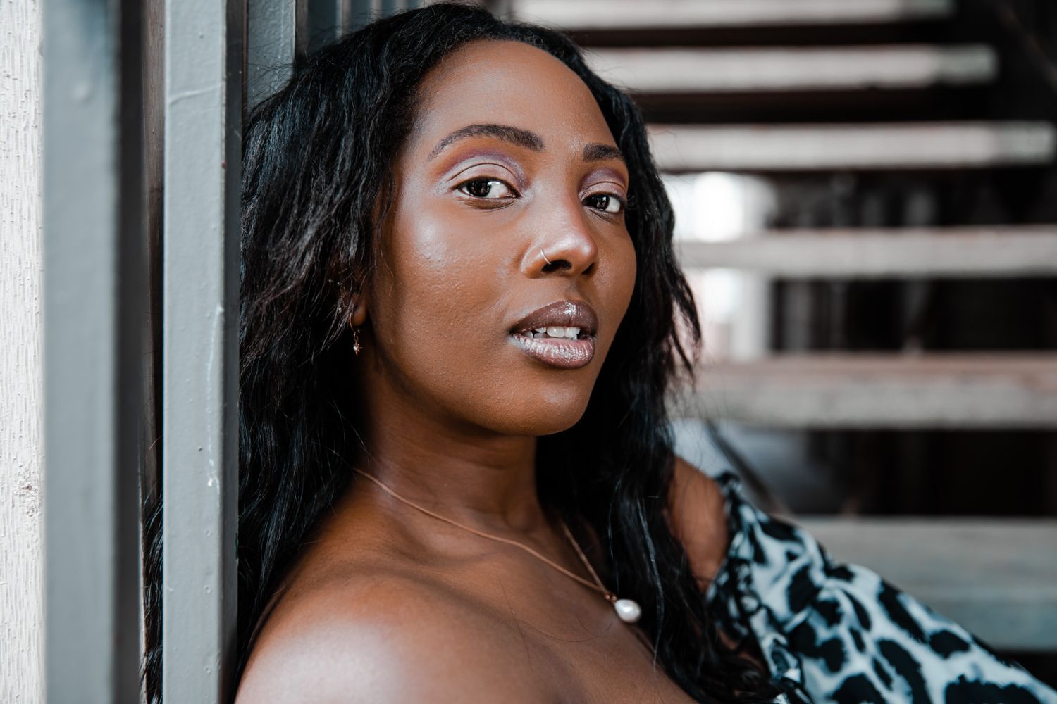 Close-up fashion portrait featuring leopard print clothing and dramatic lighting.