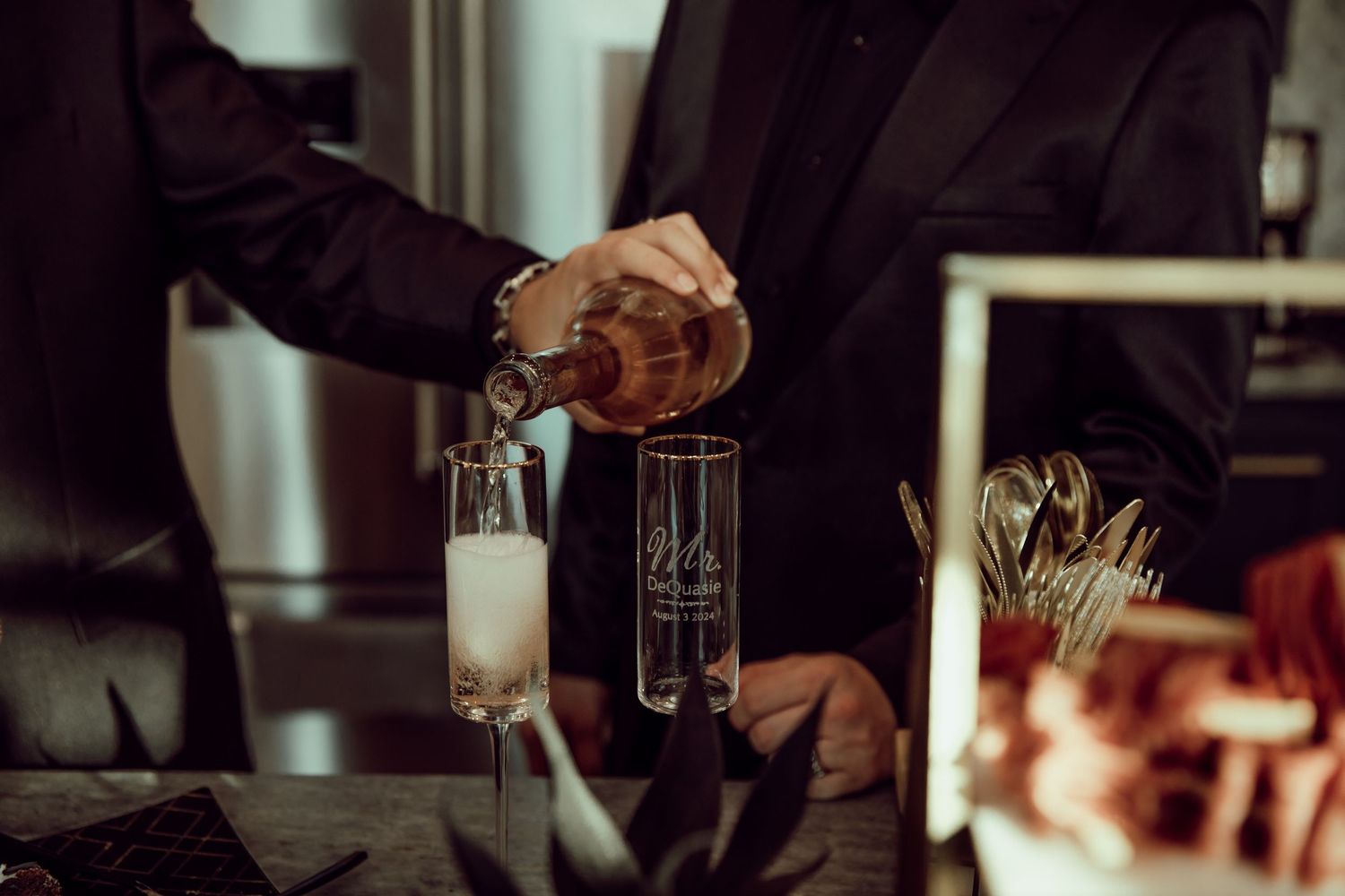 Dark moody interior shot of glasses and drinks at bar counter.