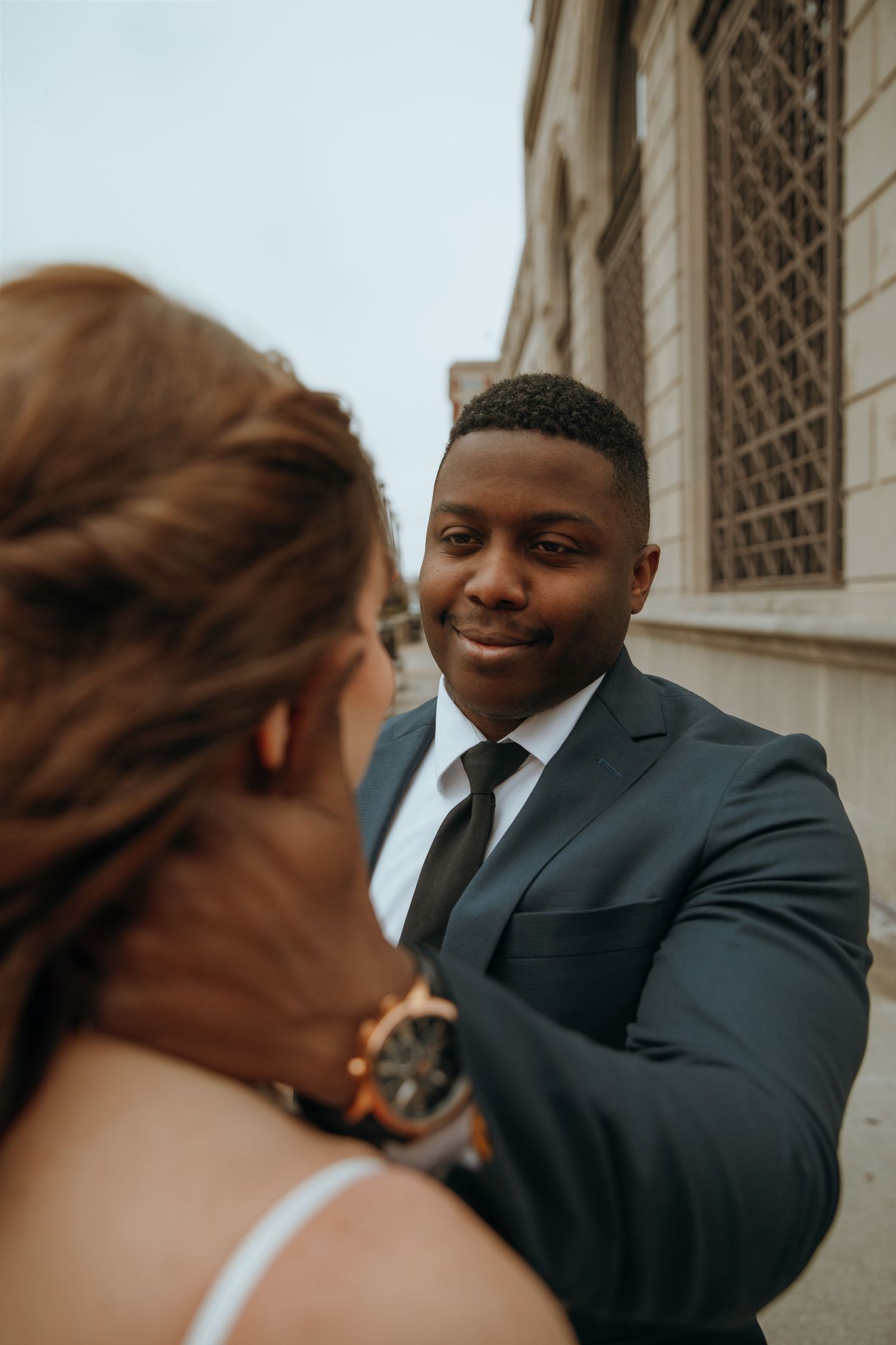 Intimate wedding portraits captured against an architectural backdrop.
