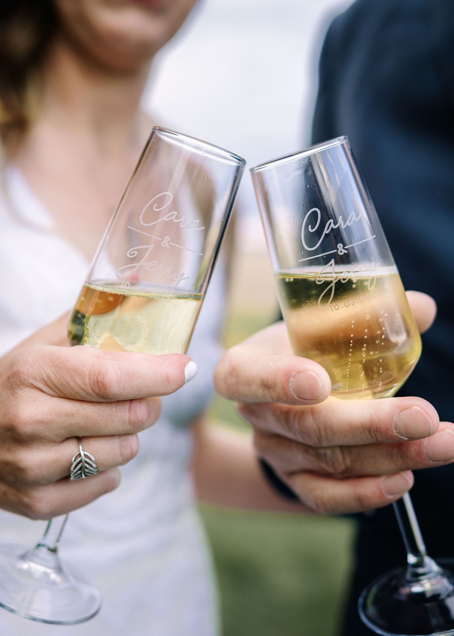 Bride and groom toasting with champagne glasses in an outdoor celebration. A photo by Bozeman wedding photographer Kelsea Laine Photography.