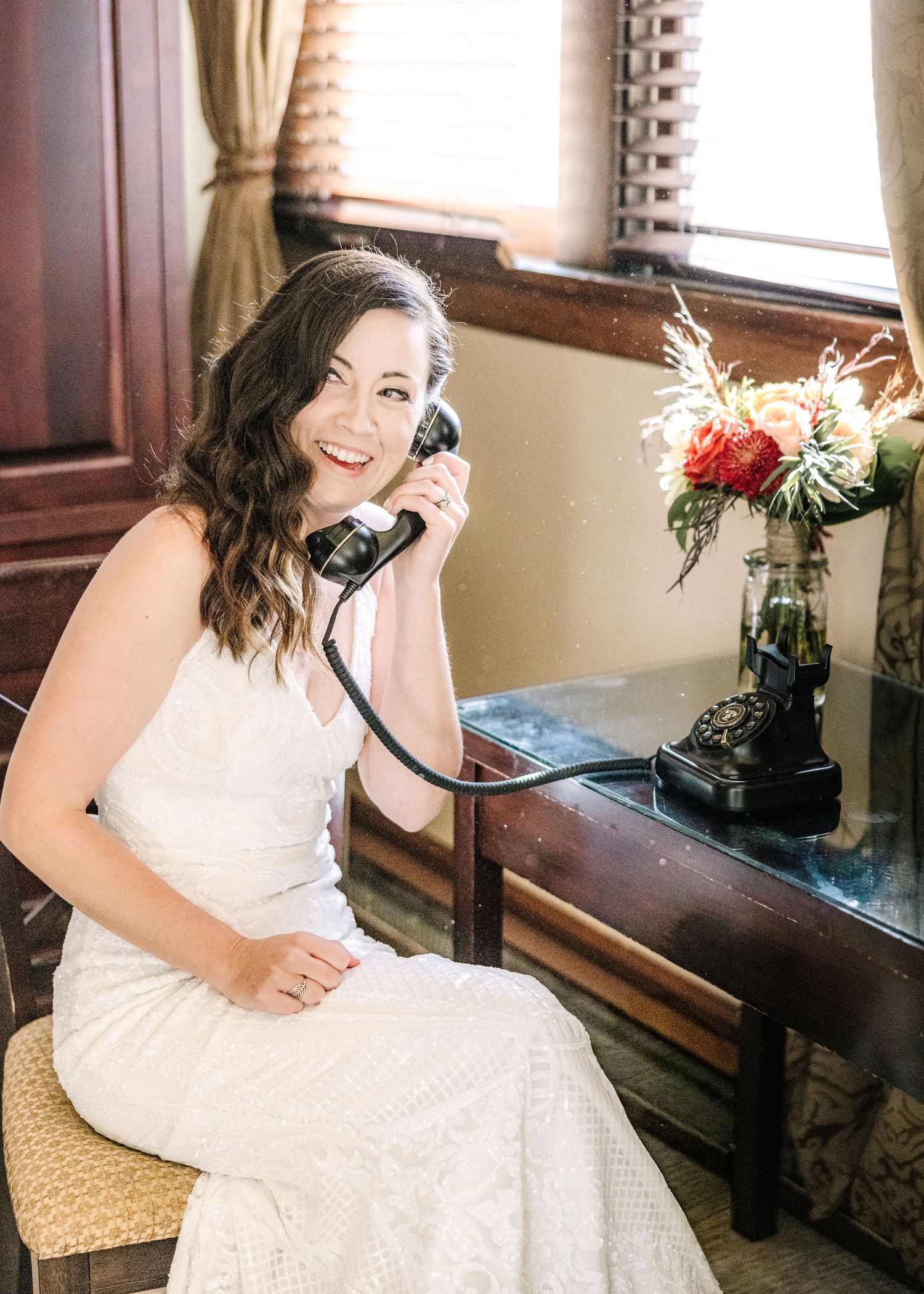 A bride in a white wedding dress sits by a window, captured in a series of candid poses.