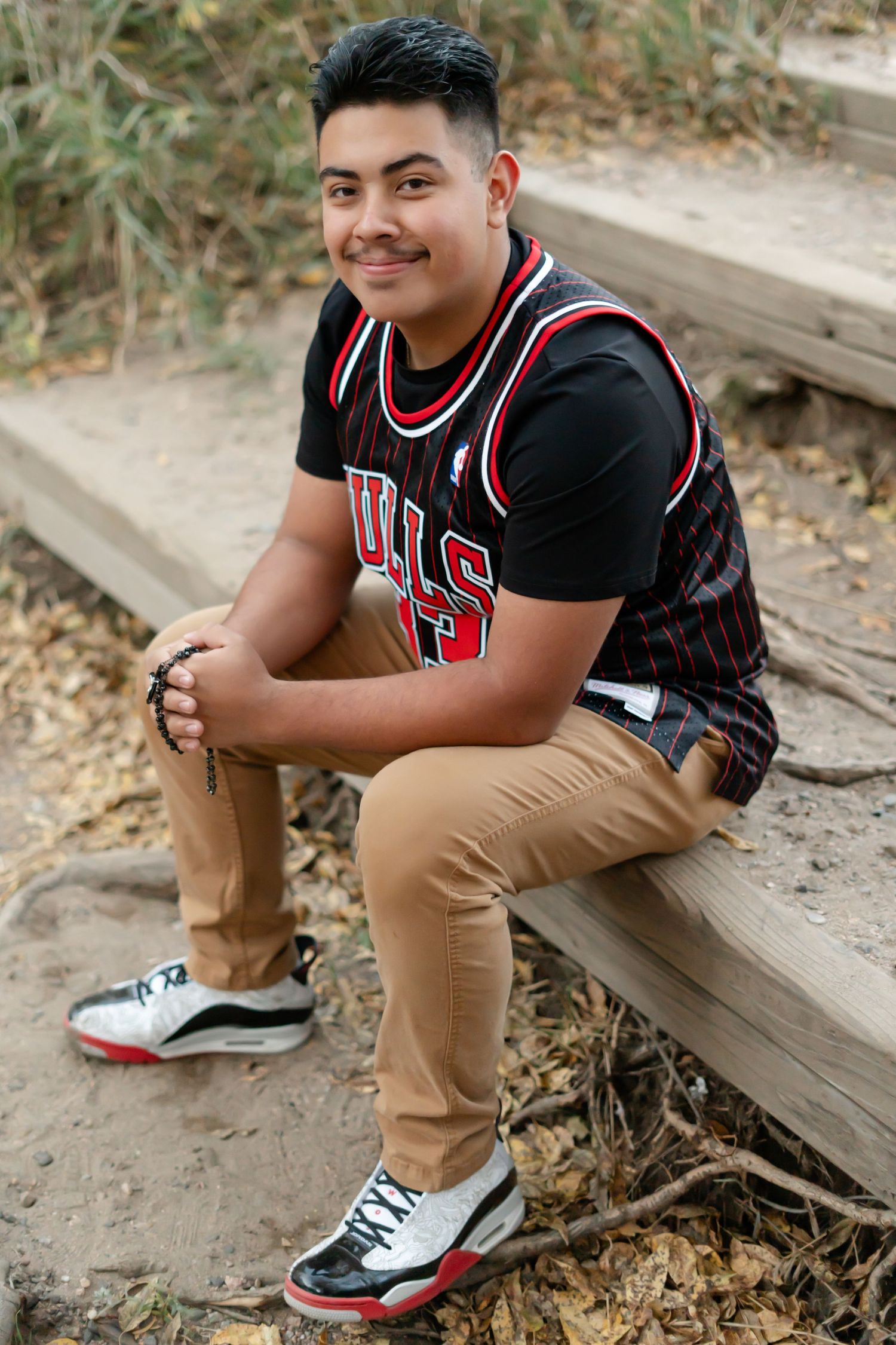 Casual outdoor portraits showing a Bulls jersey and khaki pants against a natural setting.