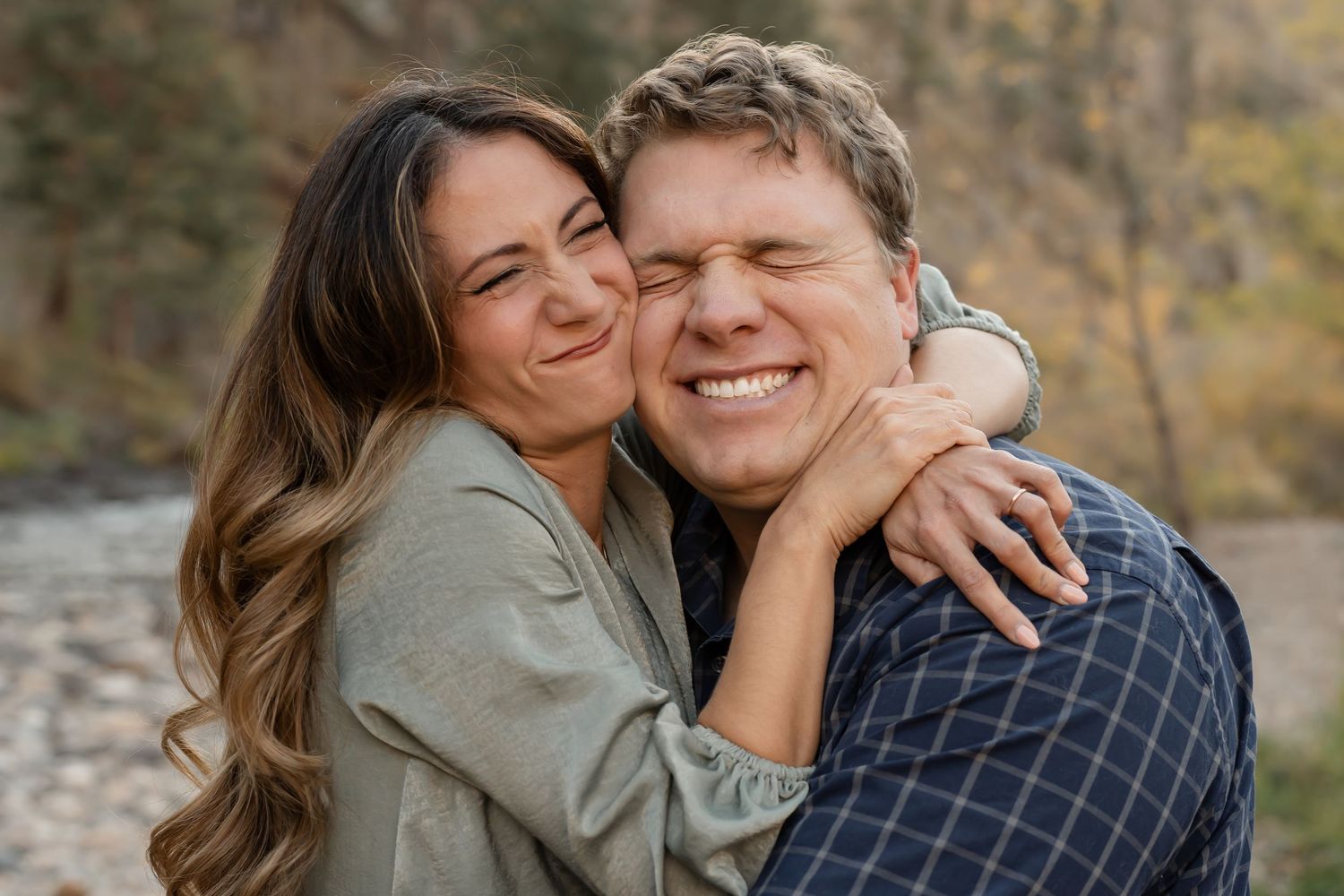 A couple shares tender moments together during an autumn outdoor photoshoot in nature.
