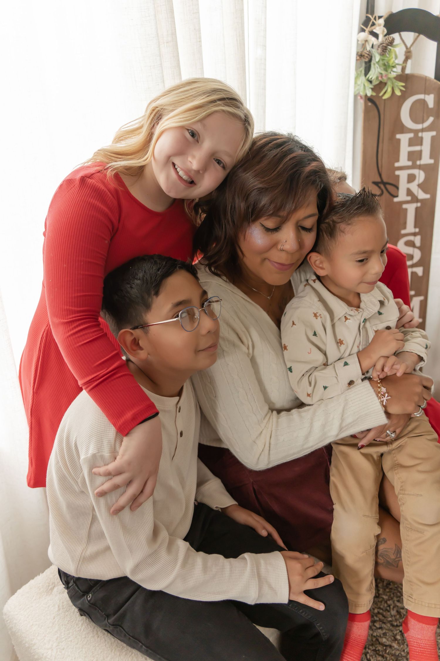 A series of candid family moments showing people embracing and sitting together on a couch during the holidays.